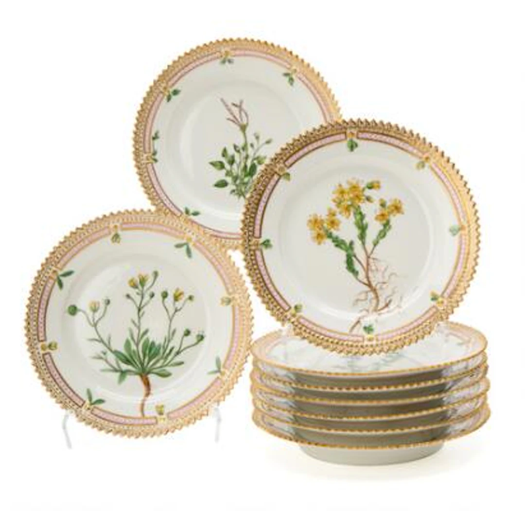 Nine "Flora Danica" enamelled and gilt bread & butter plates. Royal