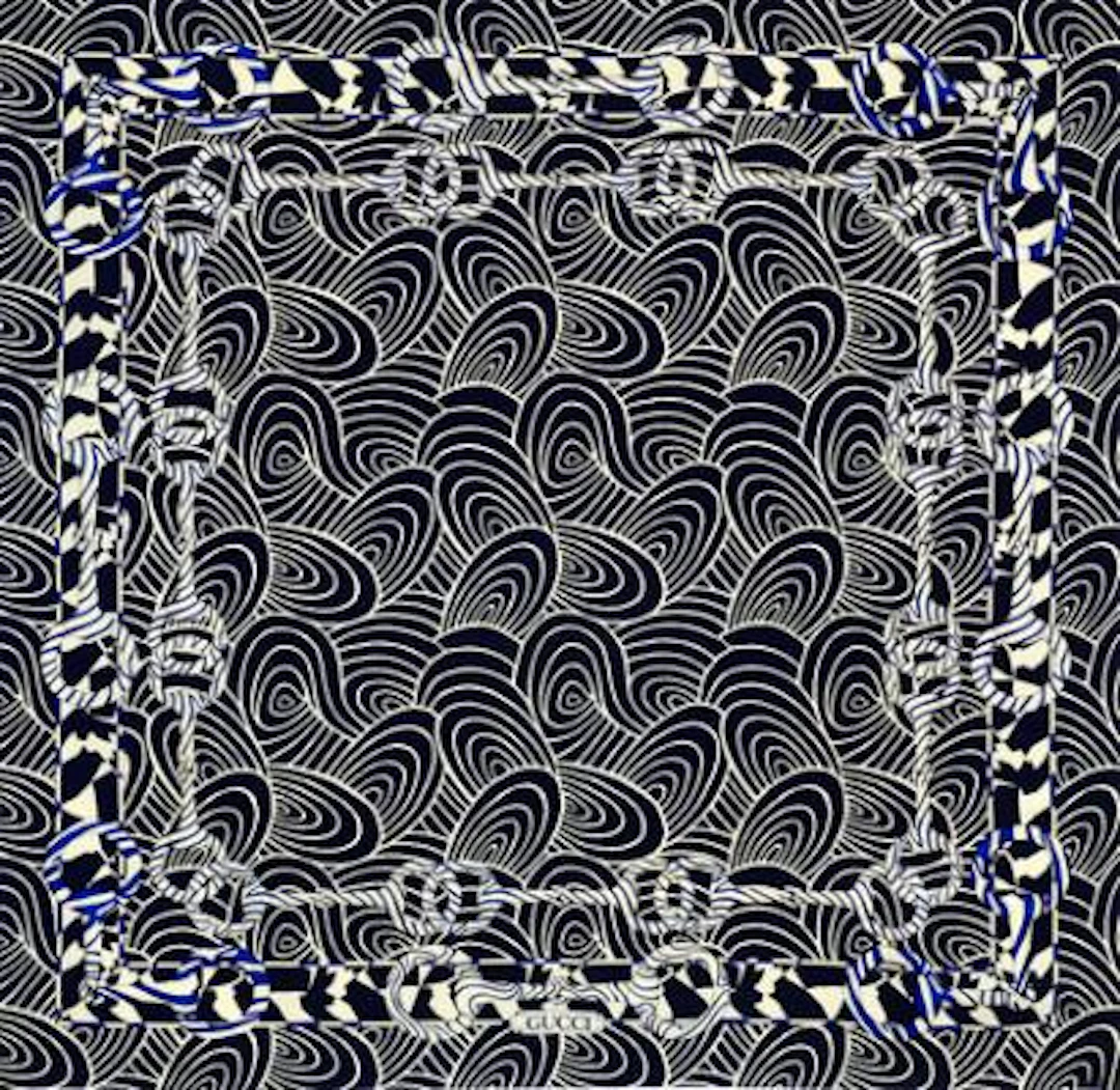 Gucci: A silk scarf with white and dark blue motif. App. 85 x 85 cm.