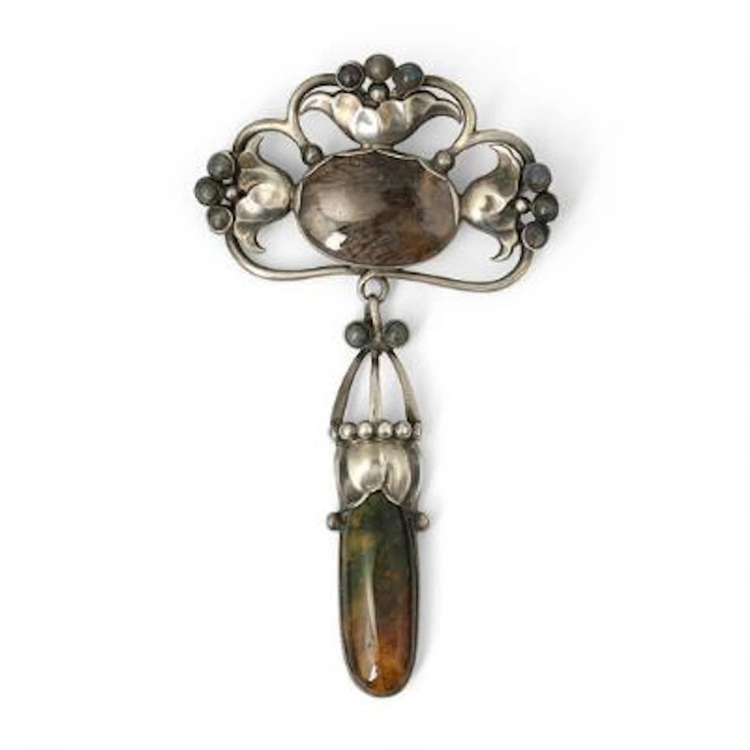 Georg Jensen: An Art Nouveau moonstone and quartz brooch of silver.