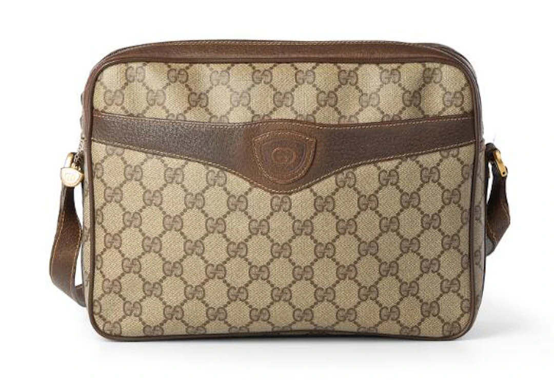 Gucci: A bag of beige monogram coated canvas with brown leather trim