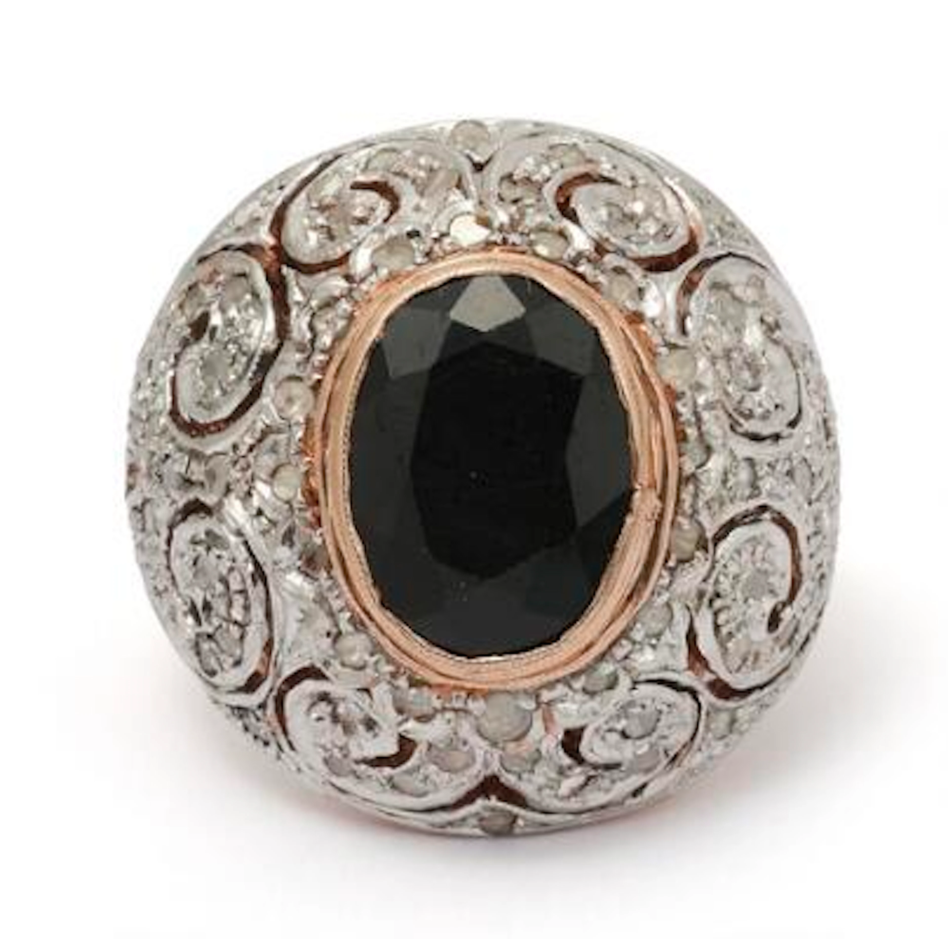 An onyx and diamond ring set with a onyx encircled by numerous diamonds.