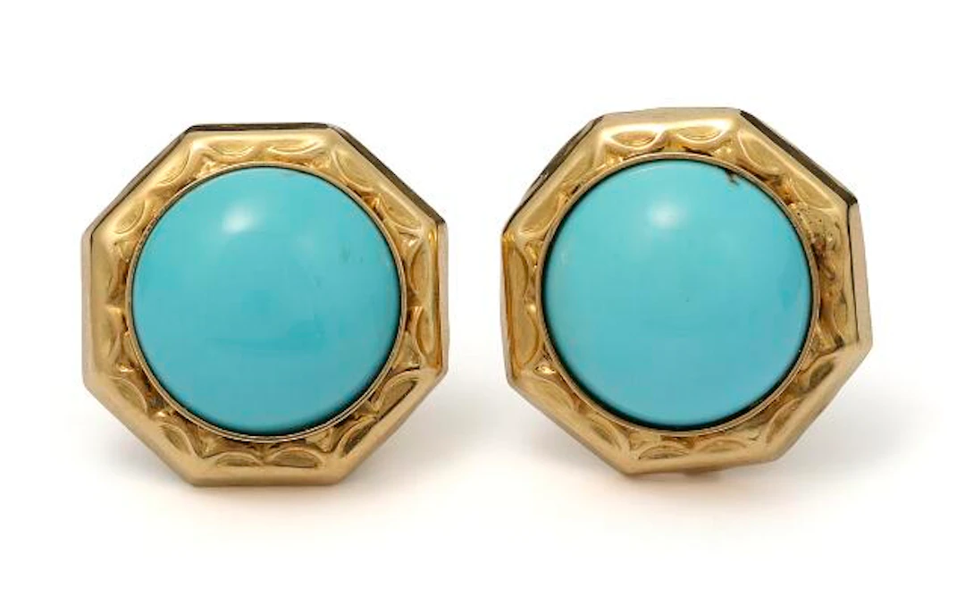A pair of turquois ear studs each set with a cabochon turquoise mounted