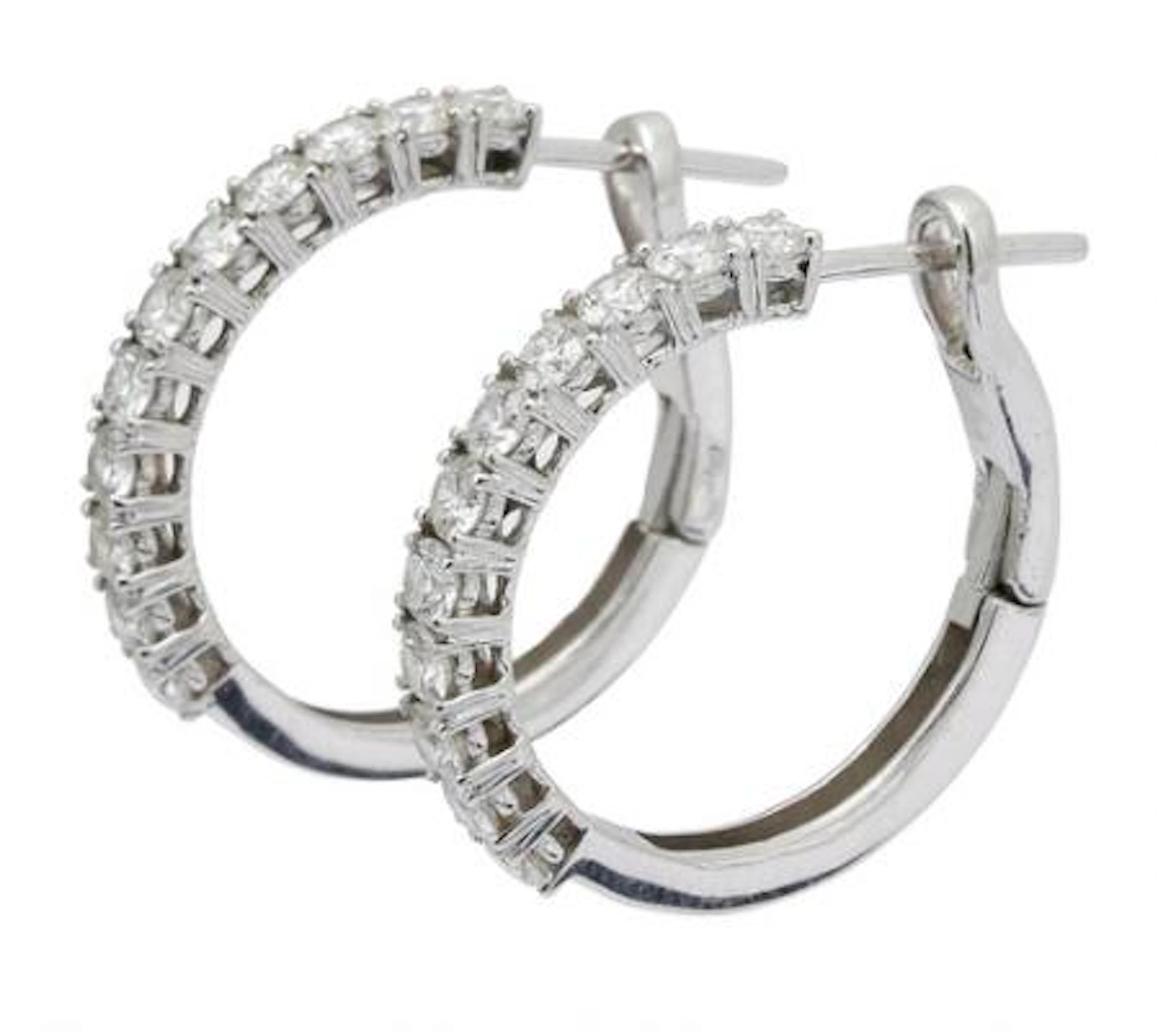 A pair of diamond ear studs each set with numerous diamonds, mounted
