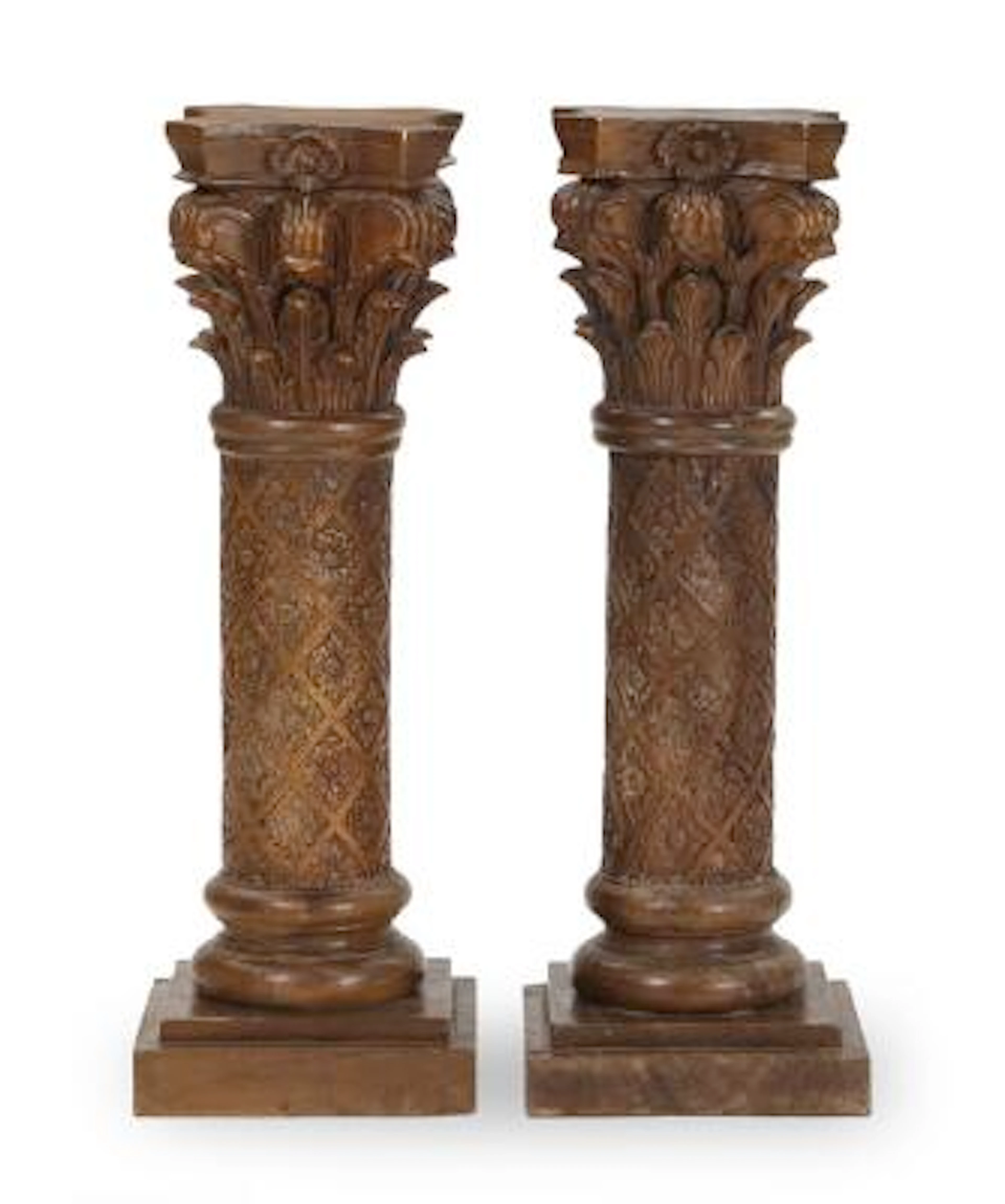 A pair of 20th century dark wood coloumns carved in Corinthian style.