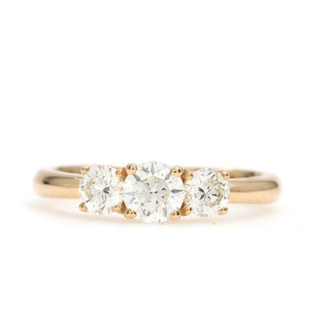 A diamond ring set with three brilliant-cut diamonds weighing a total