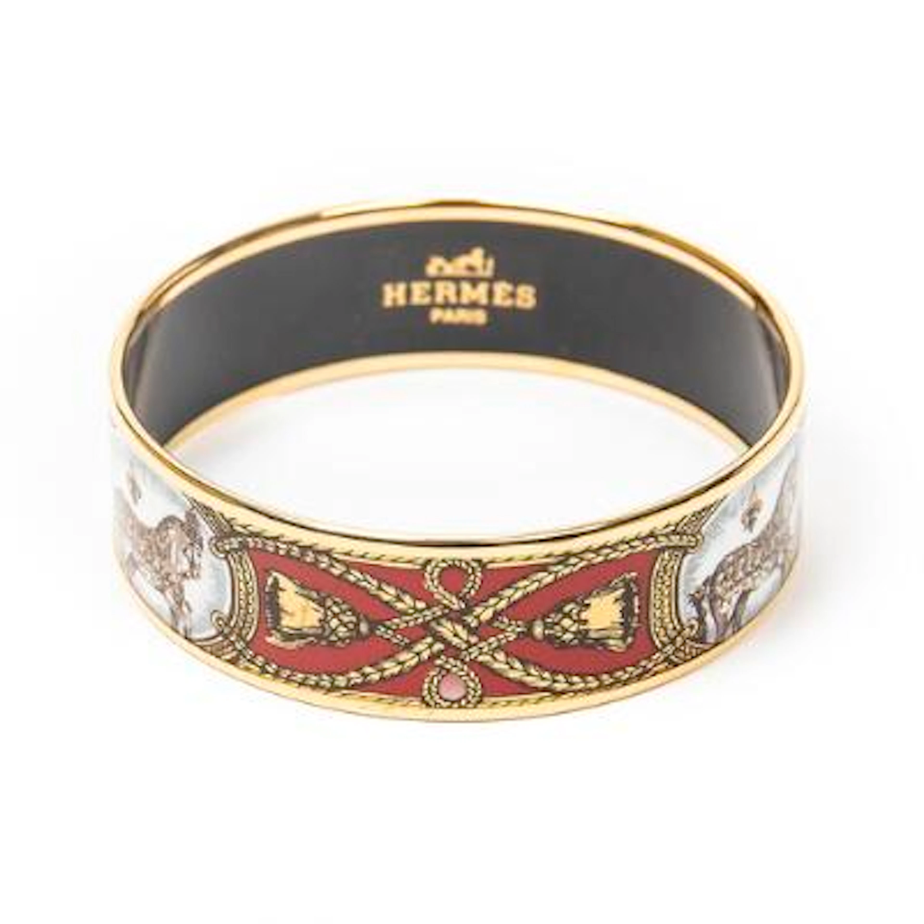 Hermès: A bangle set with enamel motif, mounted in gold coloured metal.