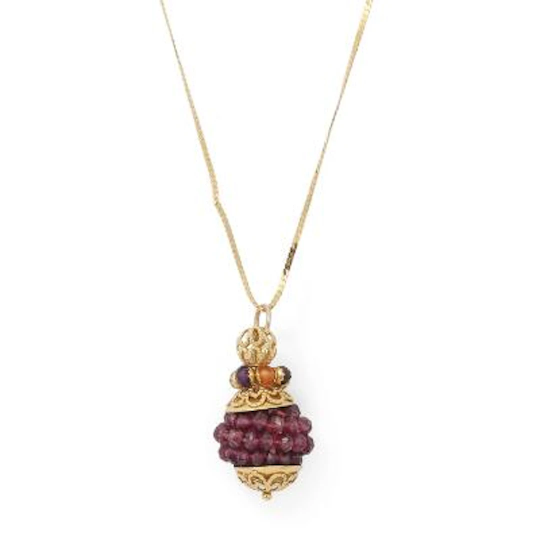 A ruby and pendant set with numerous faceted ruby beads mounted in