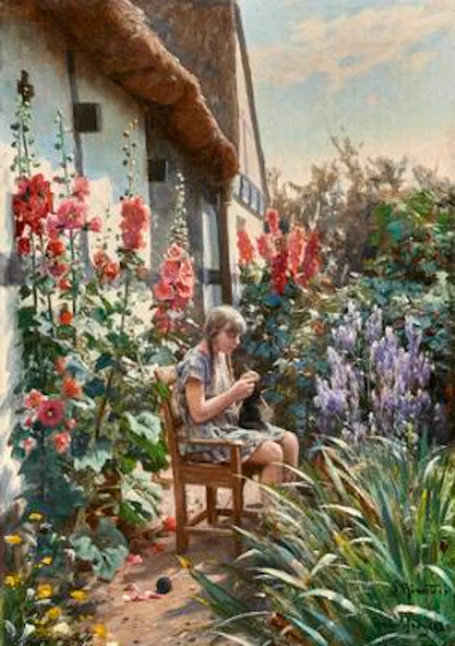 Peder Mønsted: A girl knitting in the garden of a farmhouse with hollyhocks.