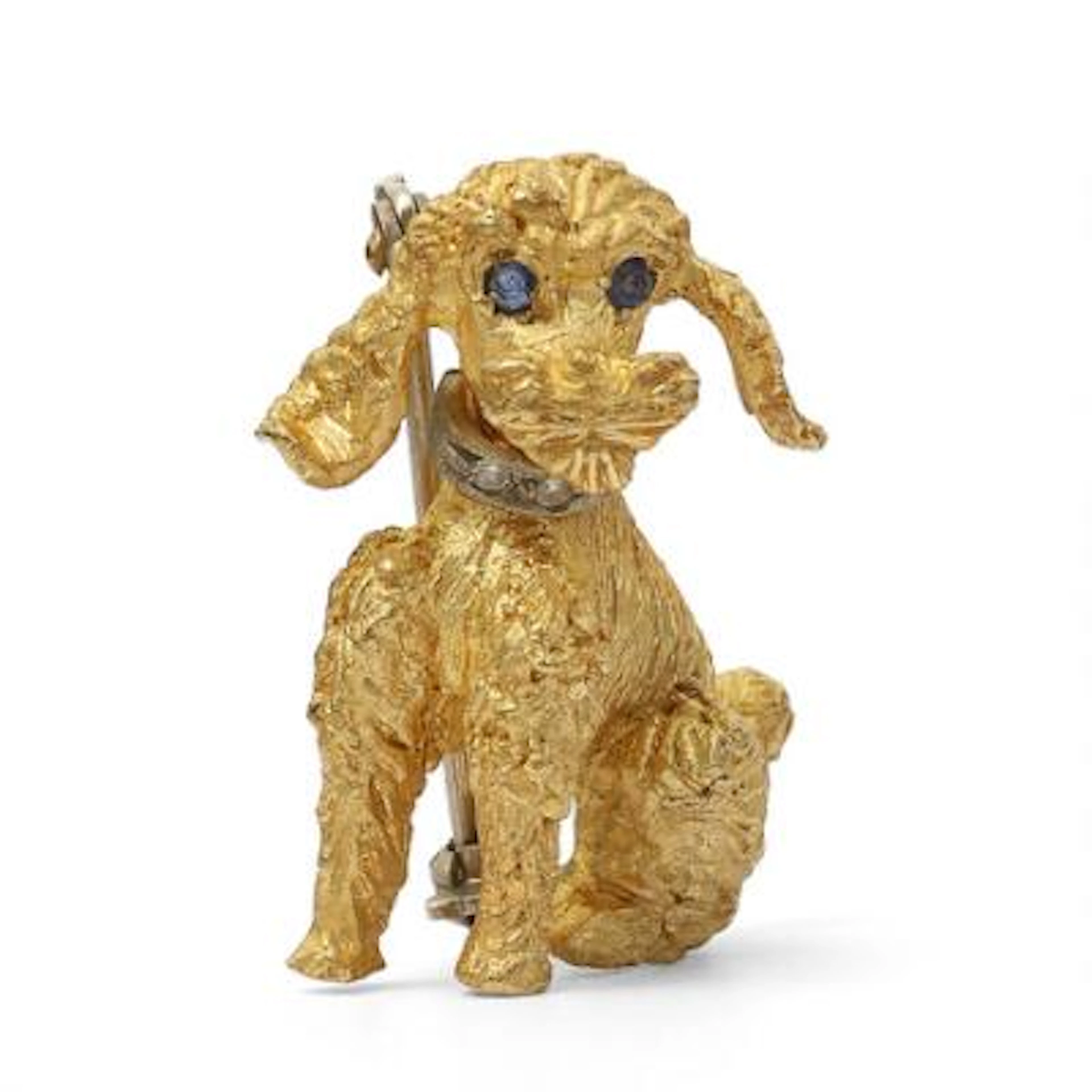 A brooch set with diamonds and blue stones, mounted in 18k gold. Weight