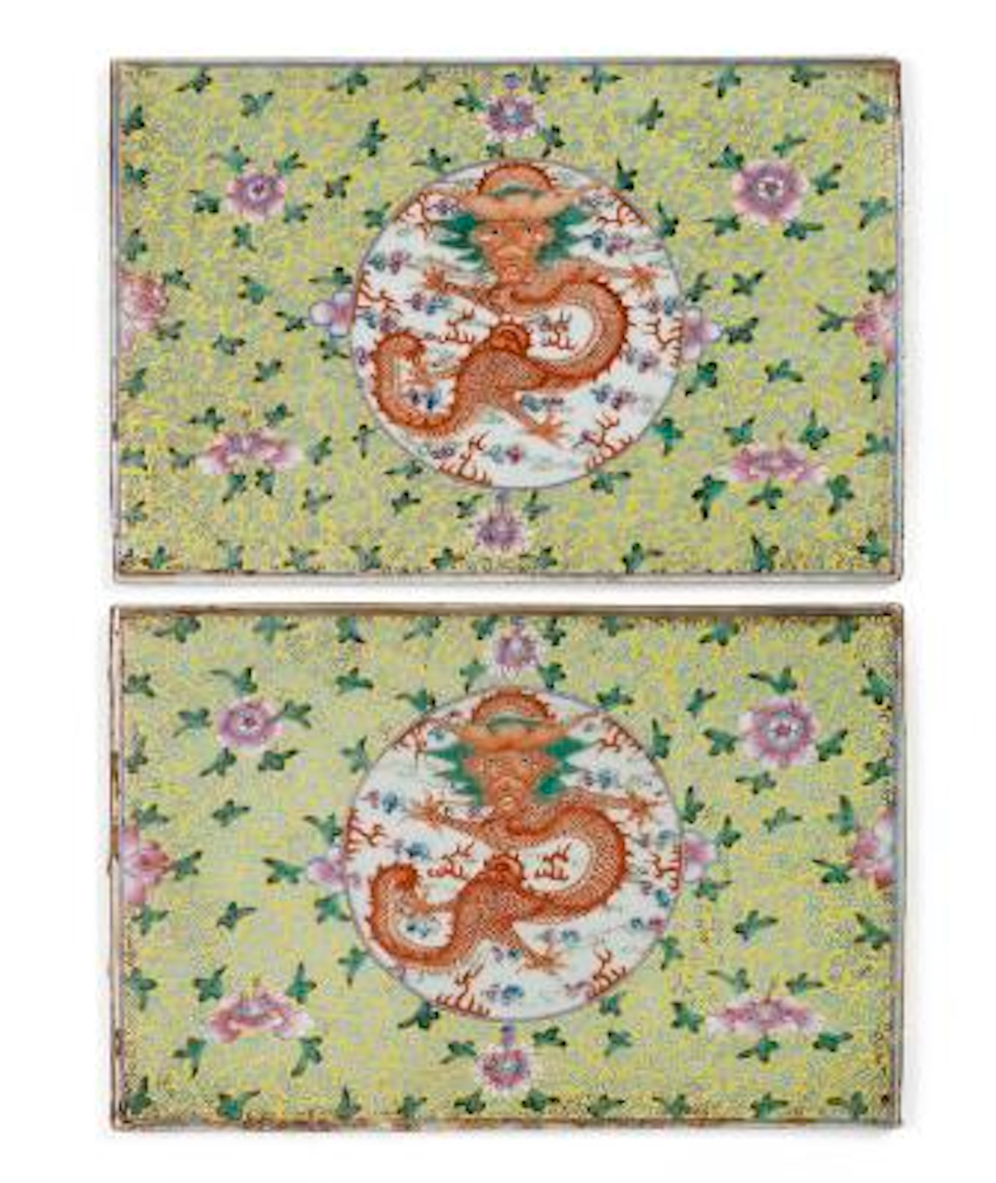A pair of famille rose plaques painted with a dragon on yellow grounds.