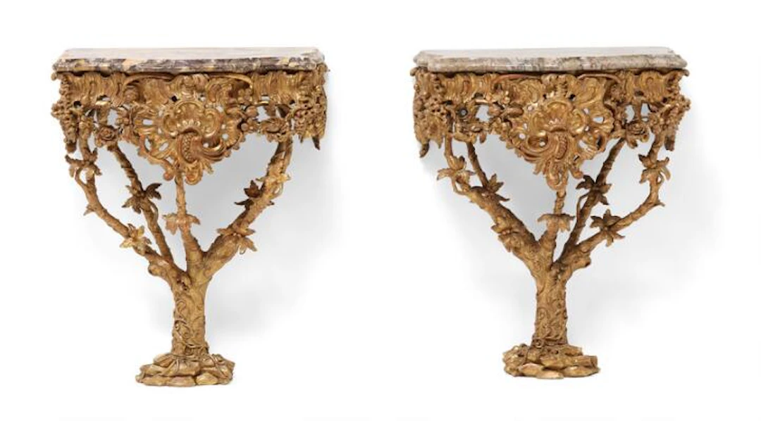 A pair of George II giltwood console tables in the manner of Thomas