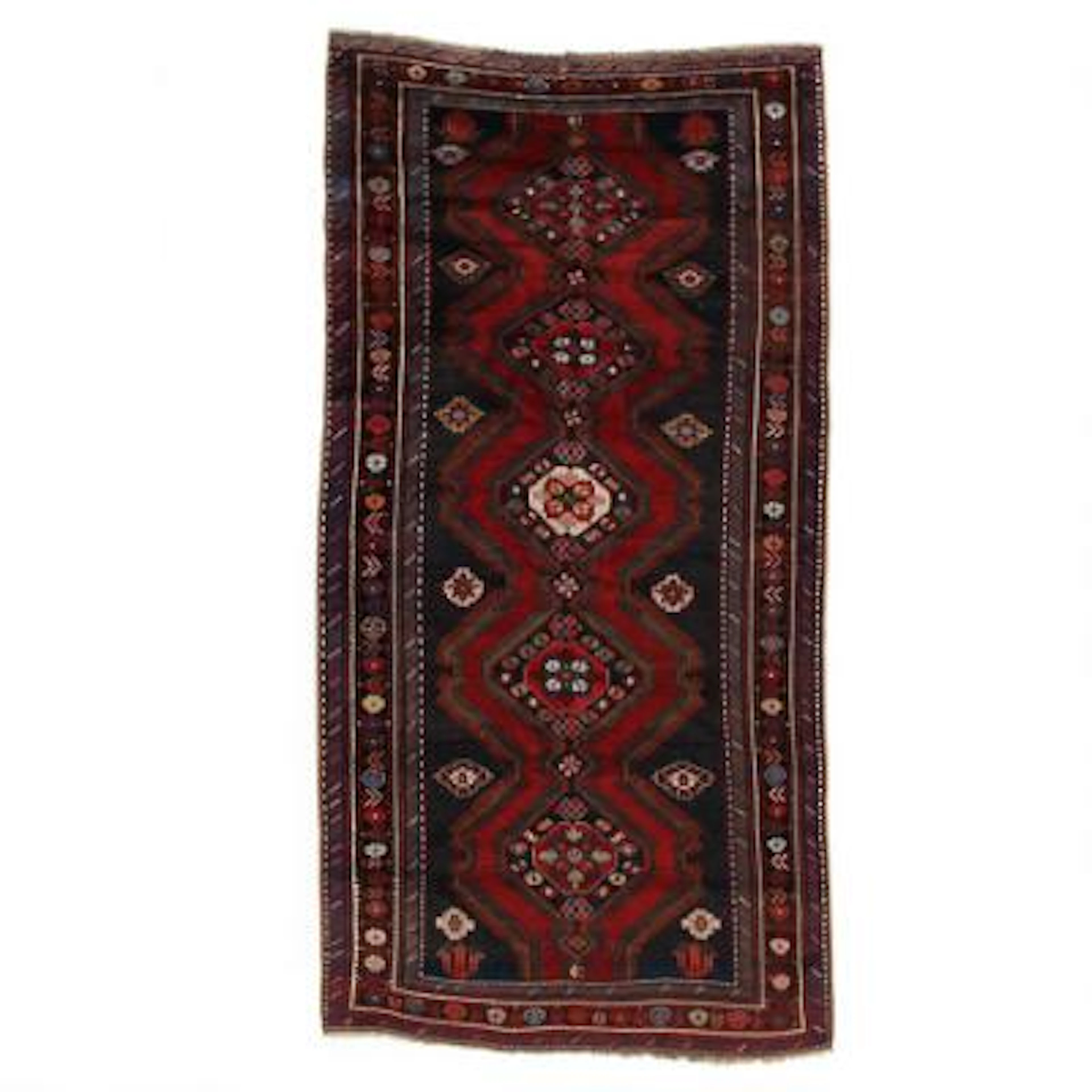 An antique Karabagh rug, Caucasus. Five connecting stylized flowermedallions