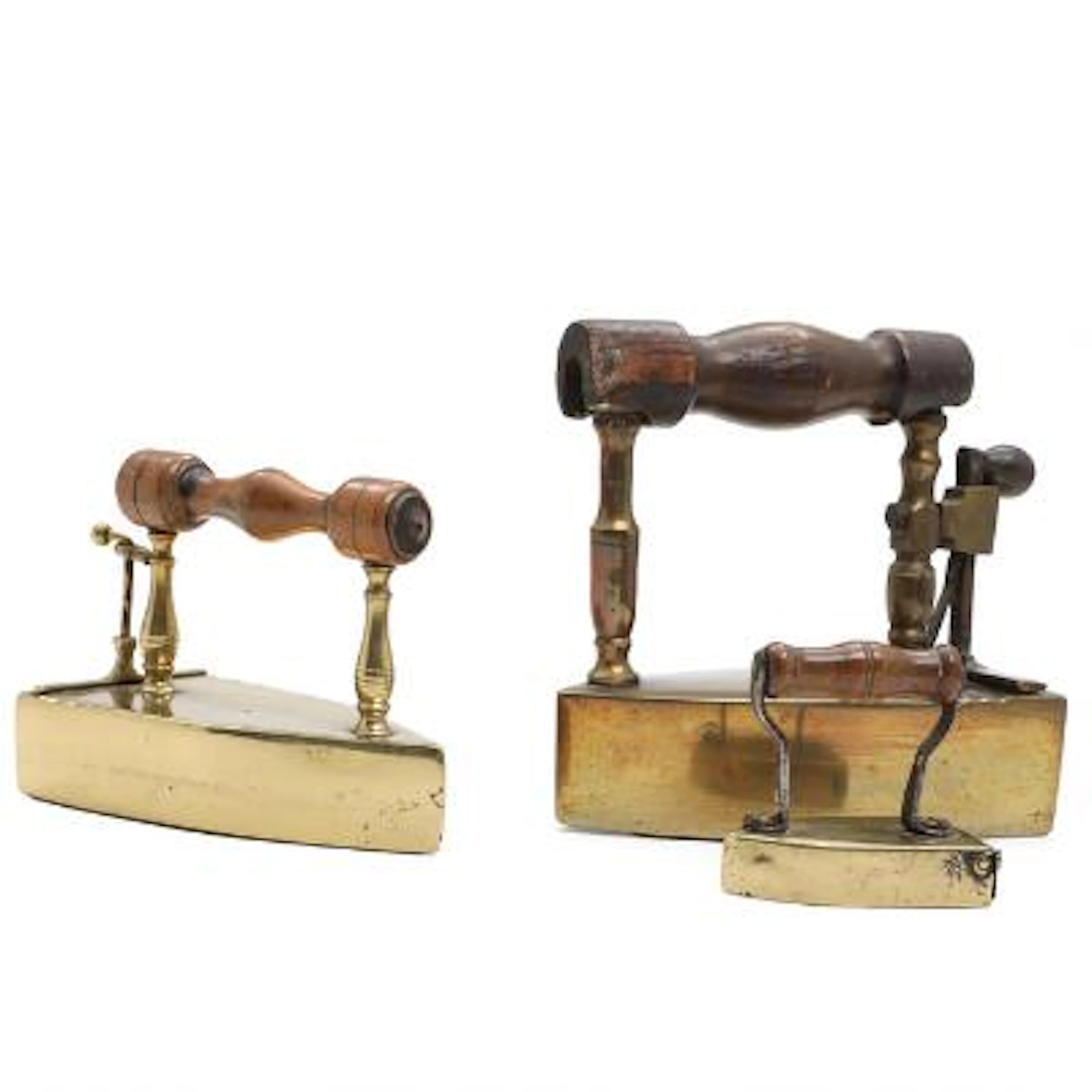 Three brass irons with handles of turned wood. 19th century. H. 8-18.