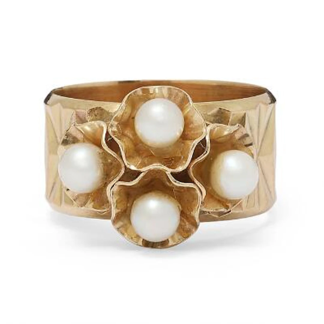 A pearl ring set with numerous pearls, mounted in 14k gold. Weight