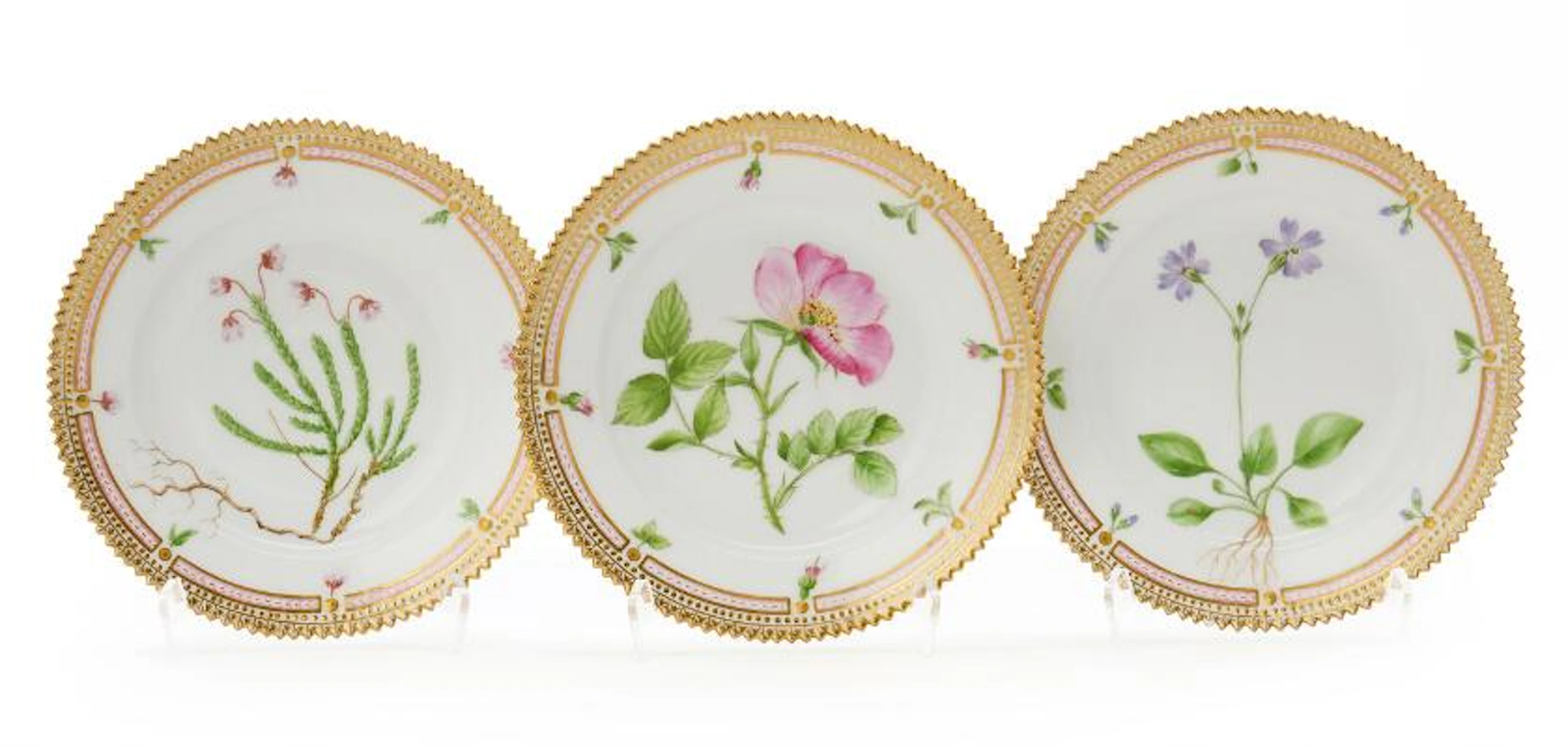 Three "Flora Danica" enamelled and gilt porcelain side plates. Royal