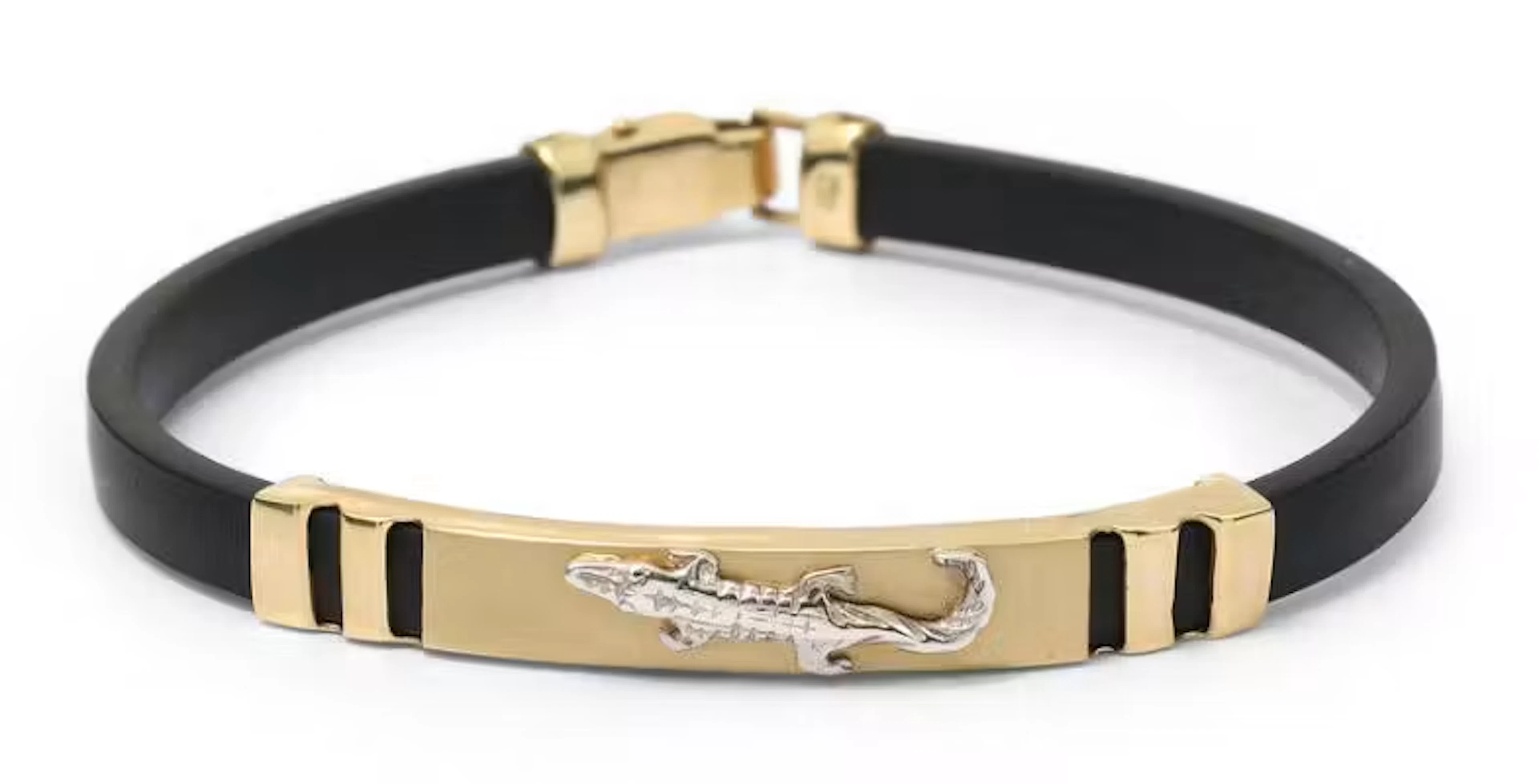A bracelet of black rubber and 14k gold and white gold. Weight app.