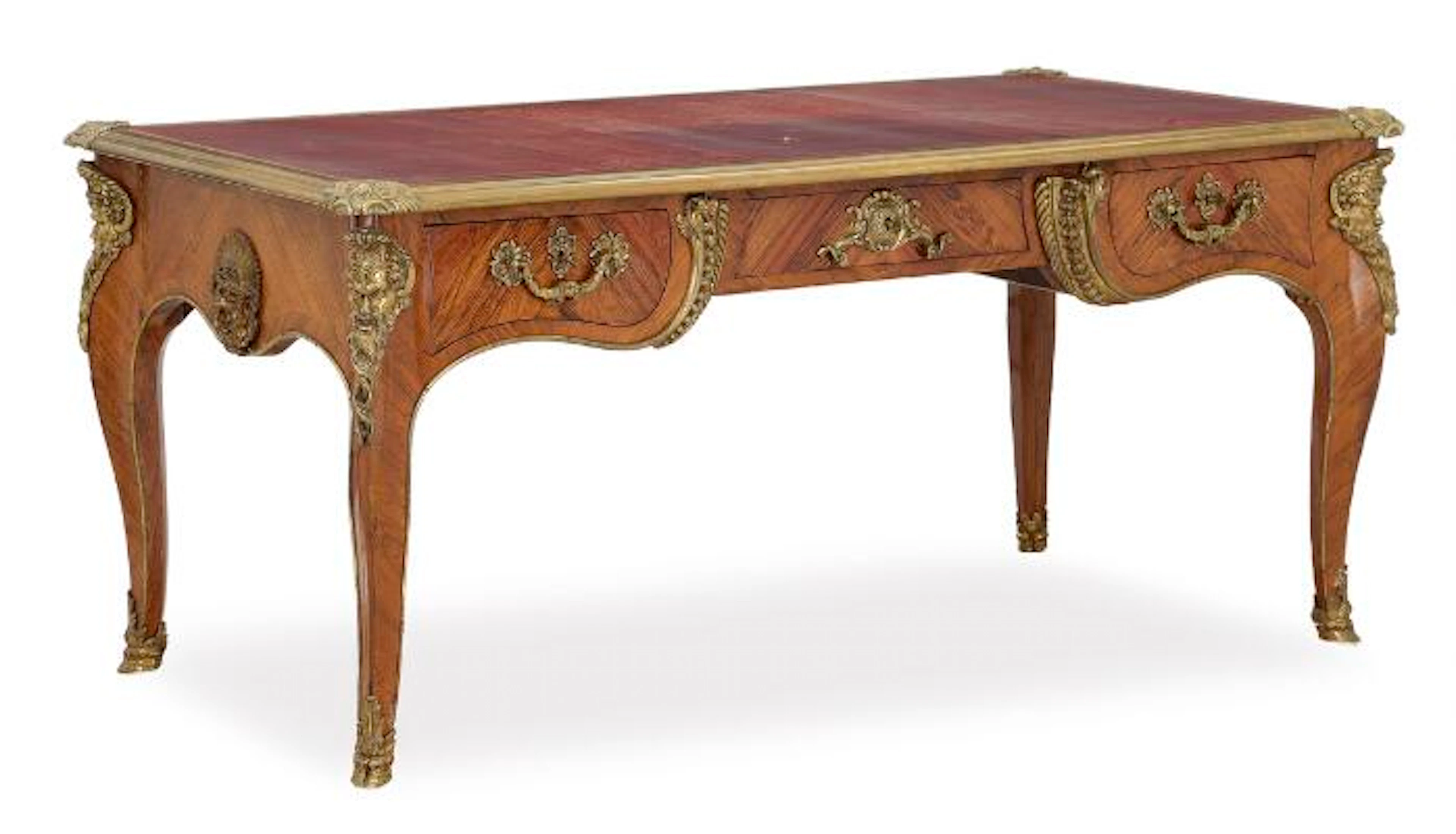 A French bureau plat of rosewood with bronze fittings and top with