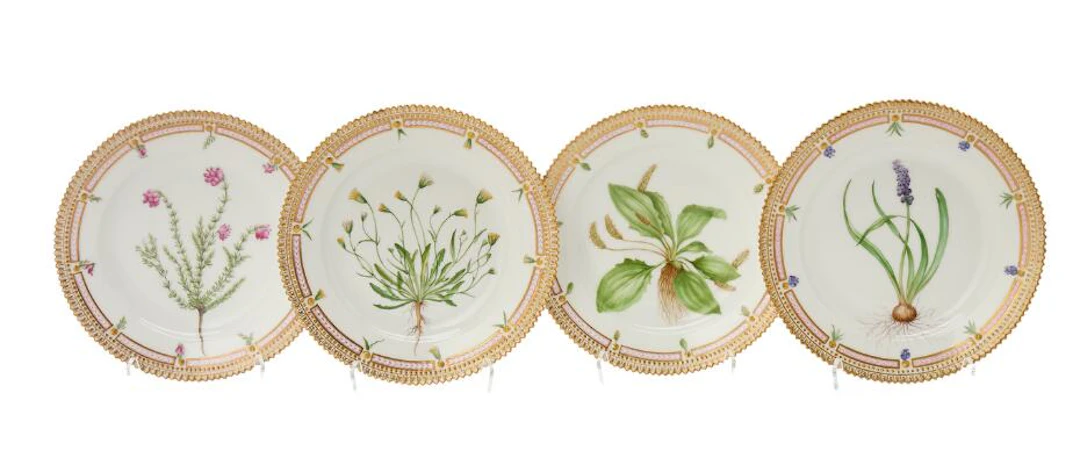 Four "Flora Danica" enamelled and gilt porcelain side plates. Royal