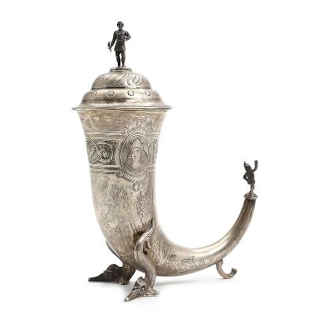 A parcel-gilt silver Historicist drinking horn with lid. Maker Christian