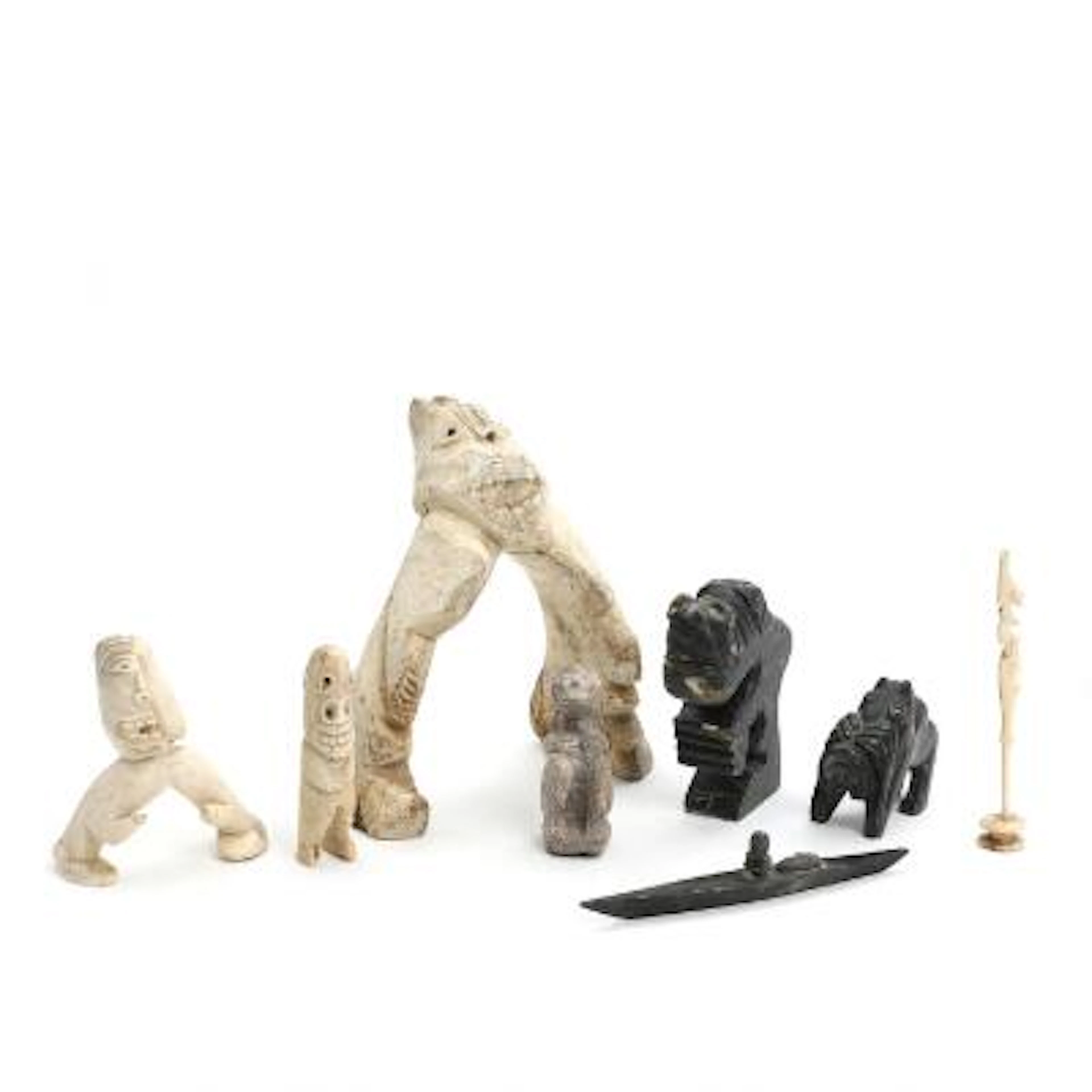 Six tupilaks, kayak and slender animal carving of bone, vertebra and