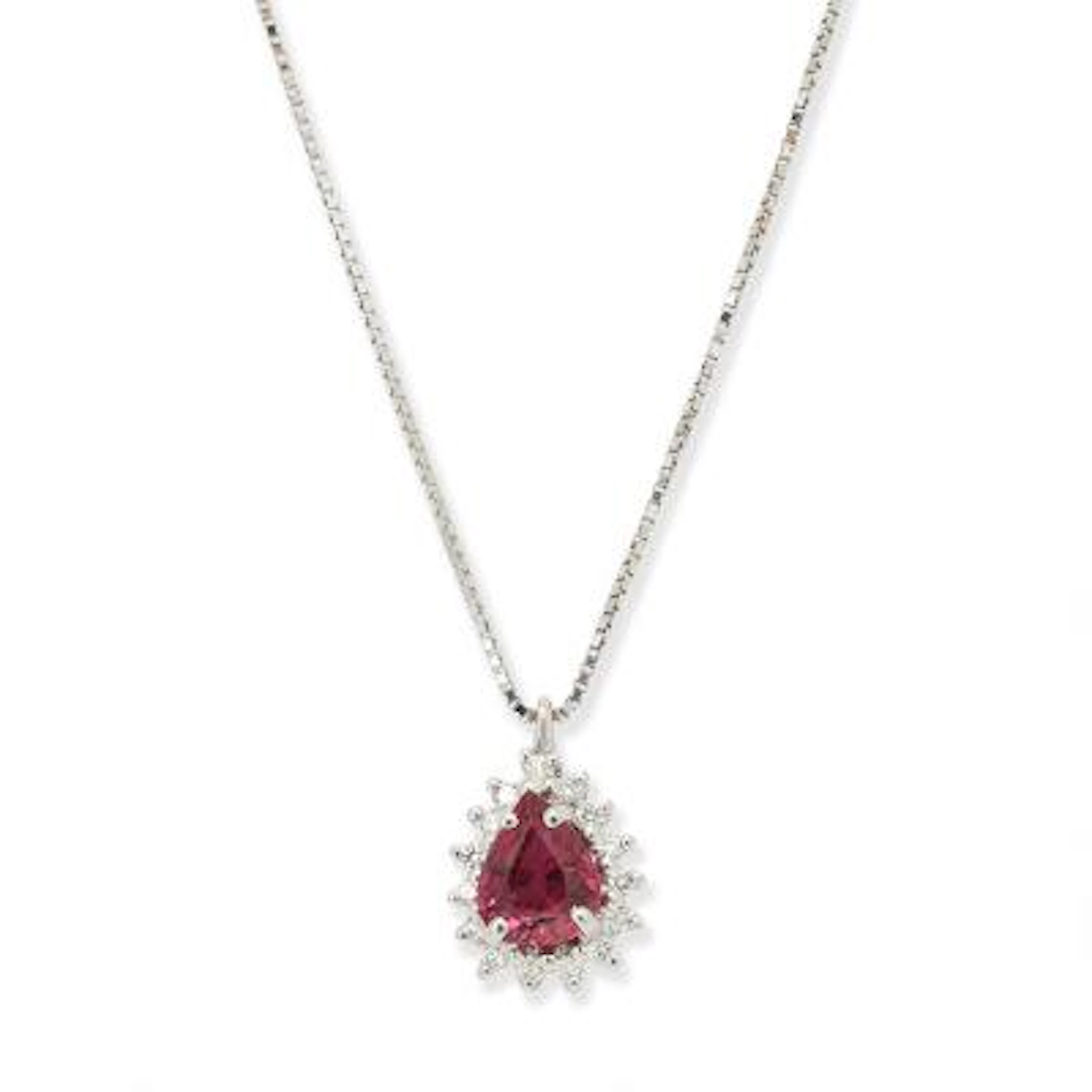 A ruby and diamond pendant set with a ruby and by diamonds mounted