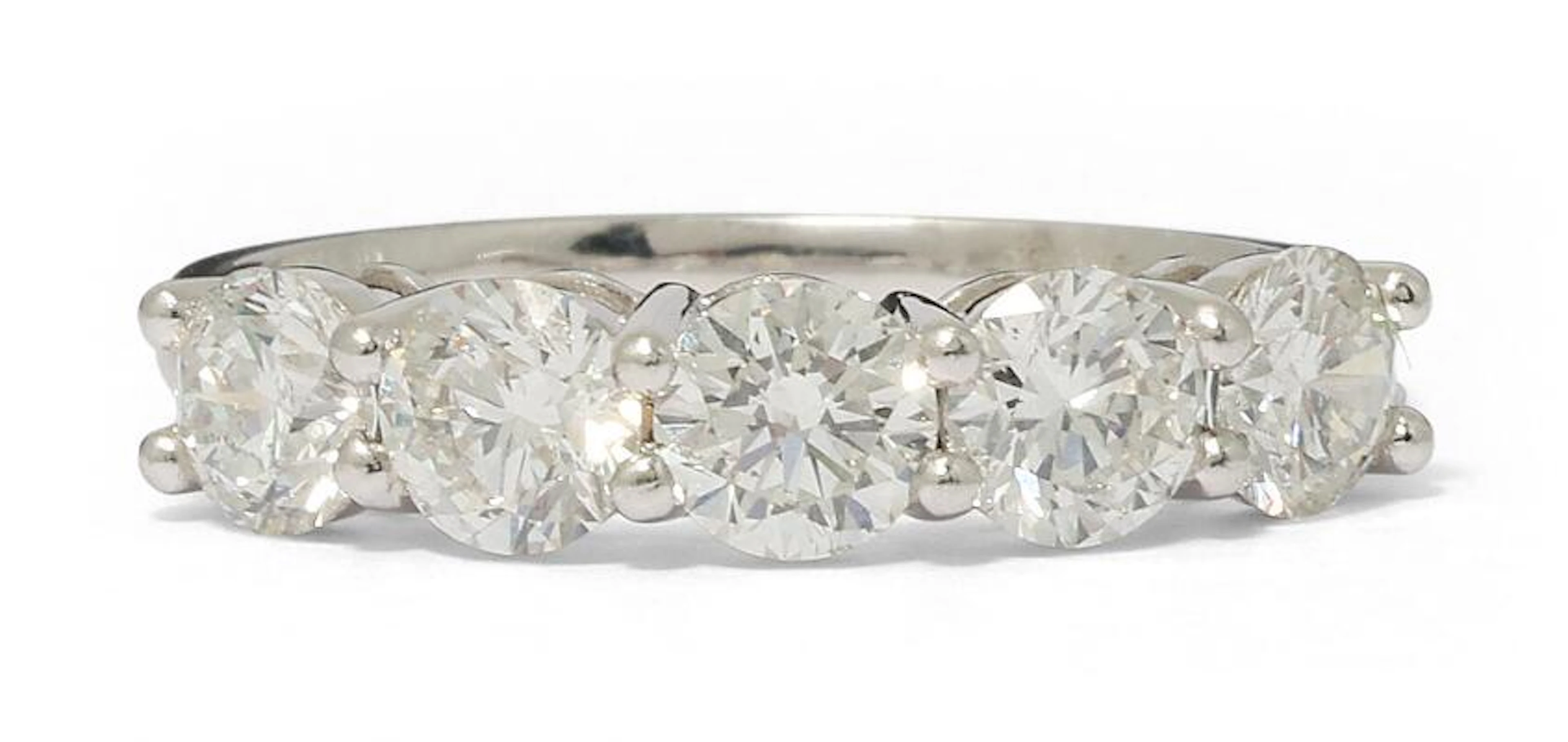 A diamond ring set with five brilliant-cut diamonds, mounted in platinum.