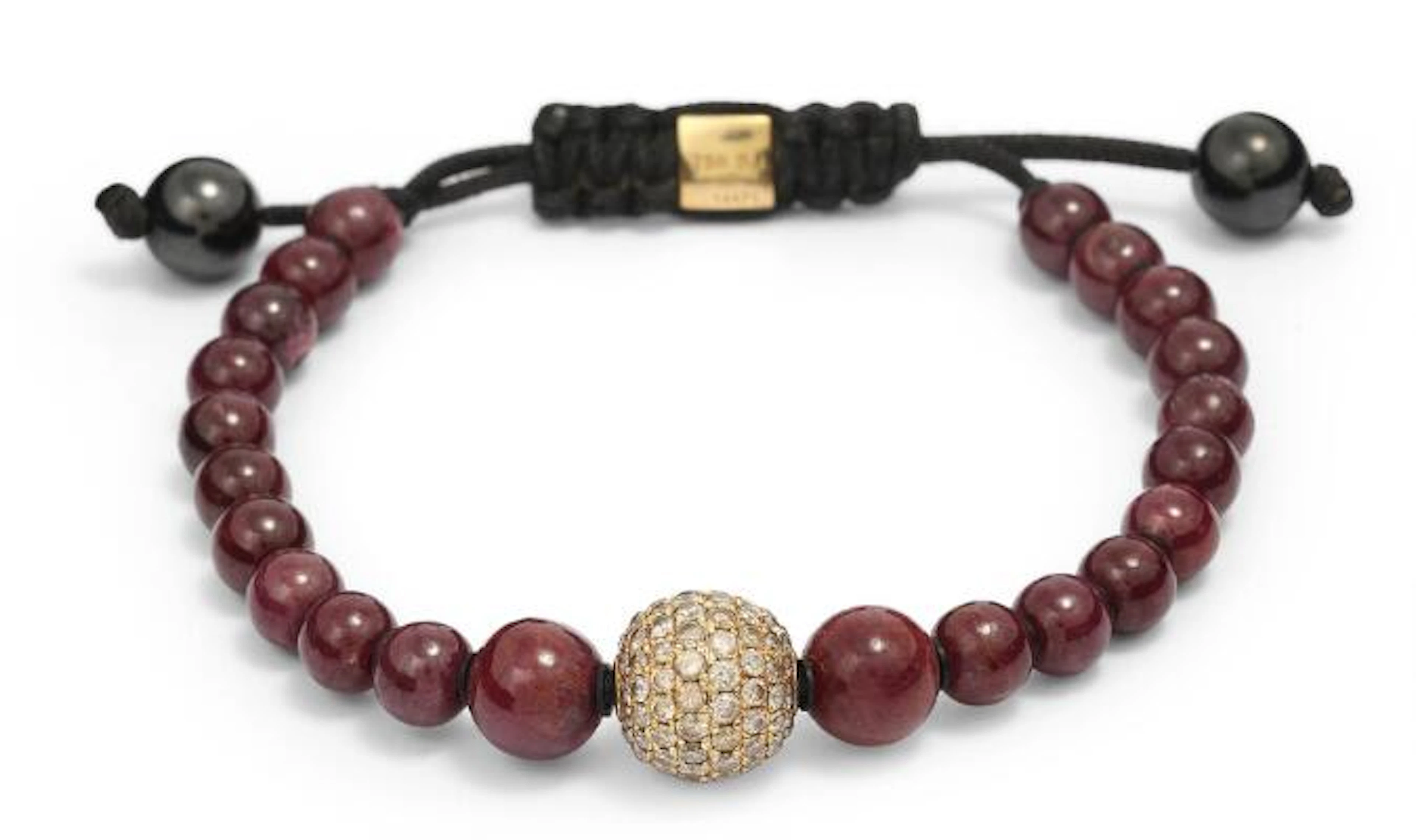 Shamballa: A ruby and diamond bracelet set with numerous polished
