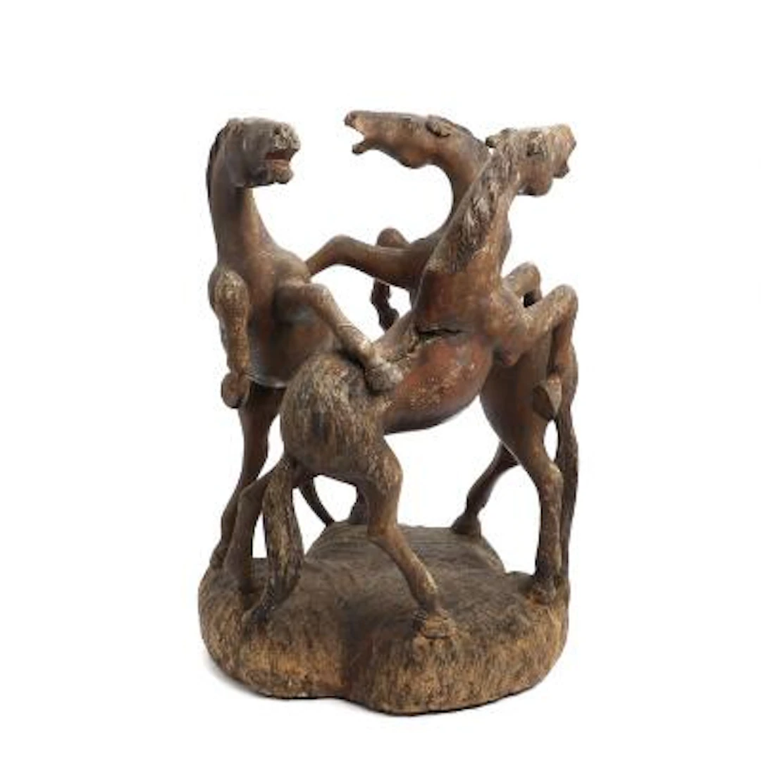 Sculpture of carved and stained wood in the form of three rearing