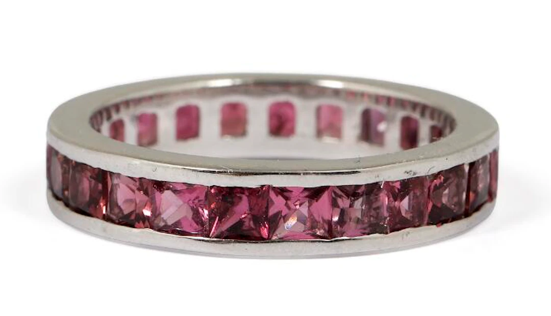A tourmaline eternity ring set with numerous tourmalines, mounted