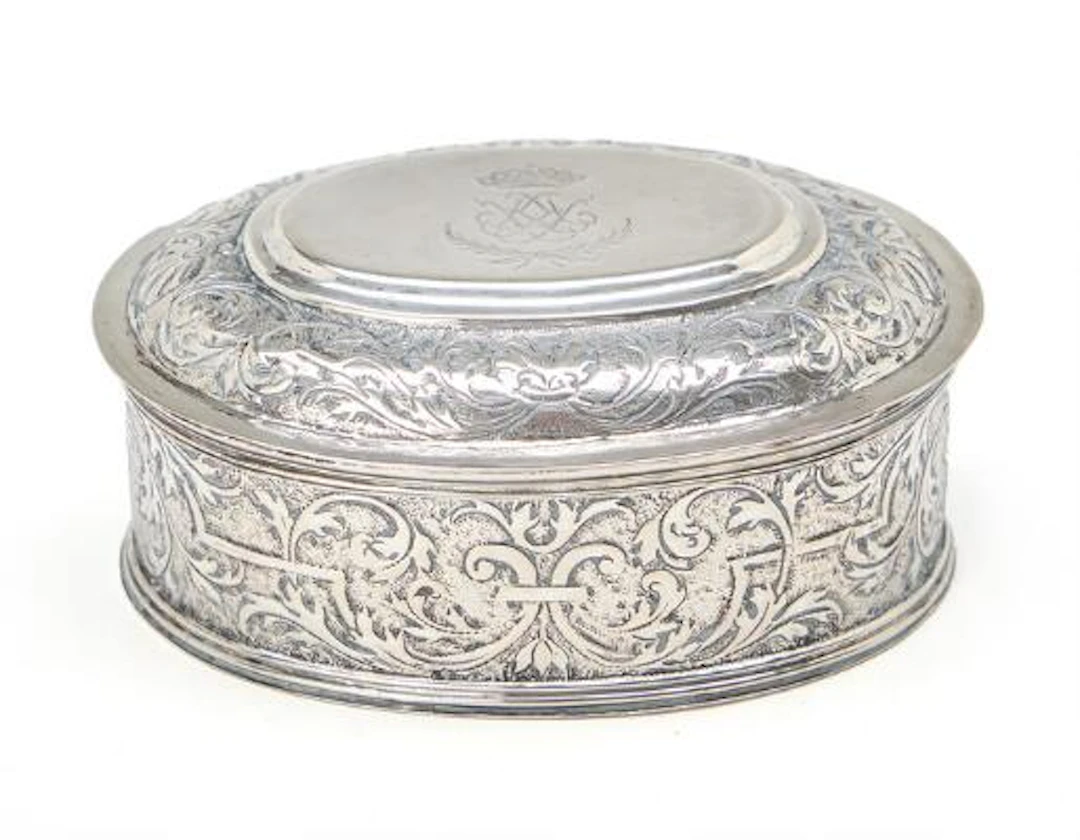 Silver lidded box, oval form, lid engraved with crowned mirror monogram.