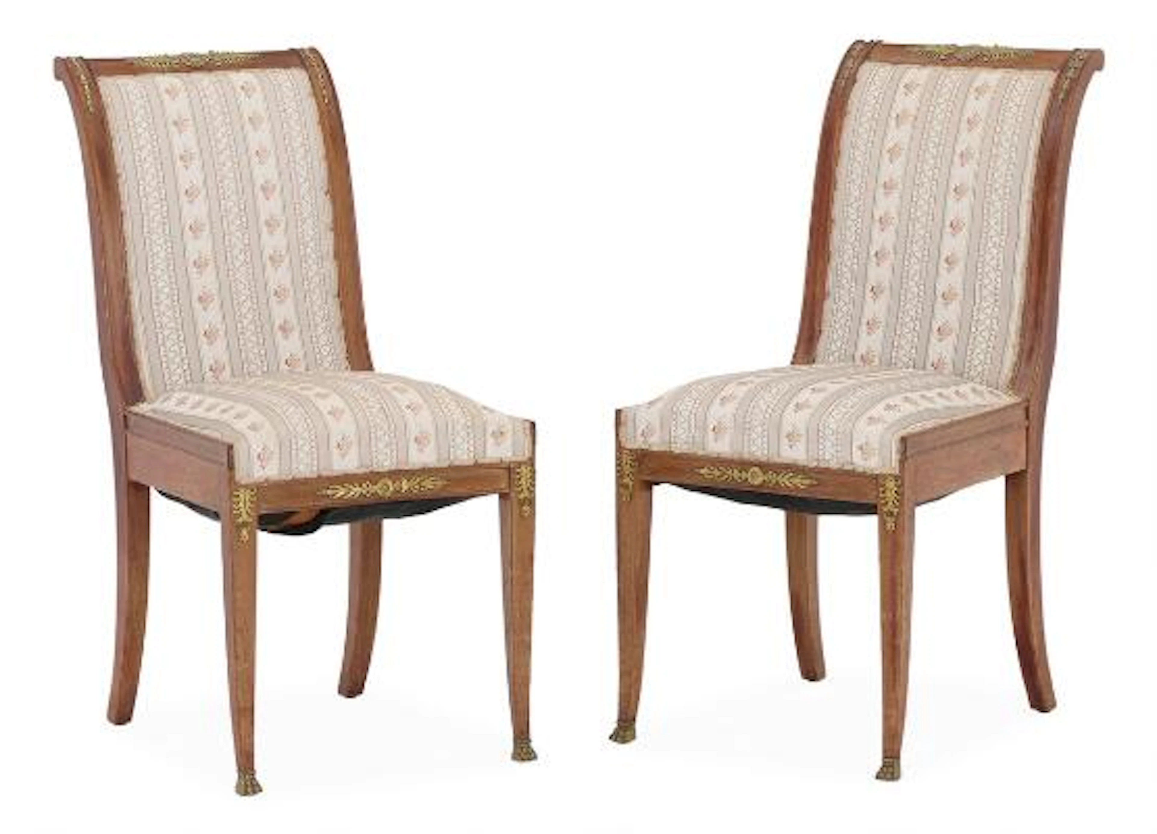 A pair of French Empire style mahogany chairs with gilt bronze fittings.