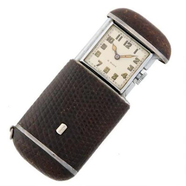 Folding watch of steel and silver clad with reptile skin. Manually