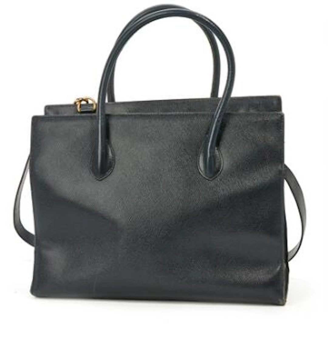 Celine: A bag of dark blue leather with gold tone hardware, two handles