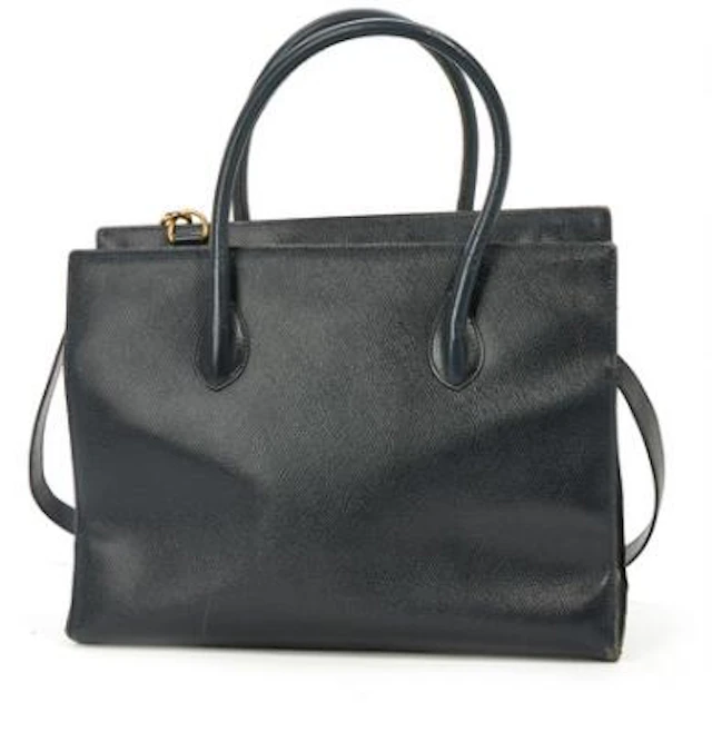 Celine: A bag of dark blue leather with gold tone hardware, two handles
