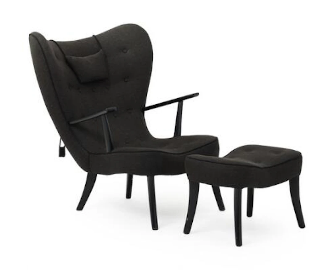 Acton Schubell: "Pragh". Easy chair and footstool with frame of black-lacquered