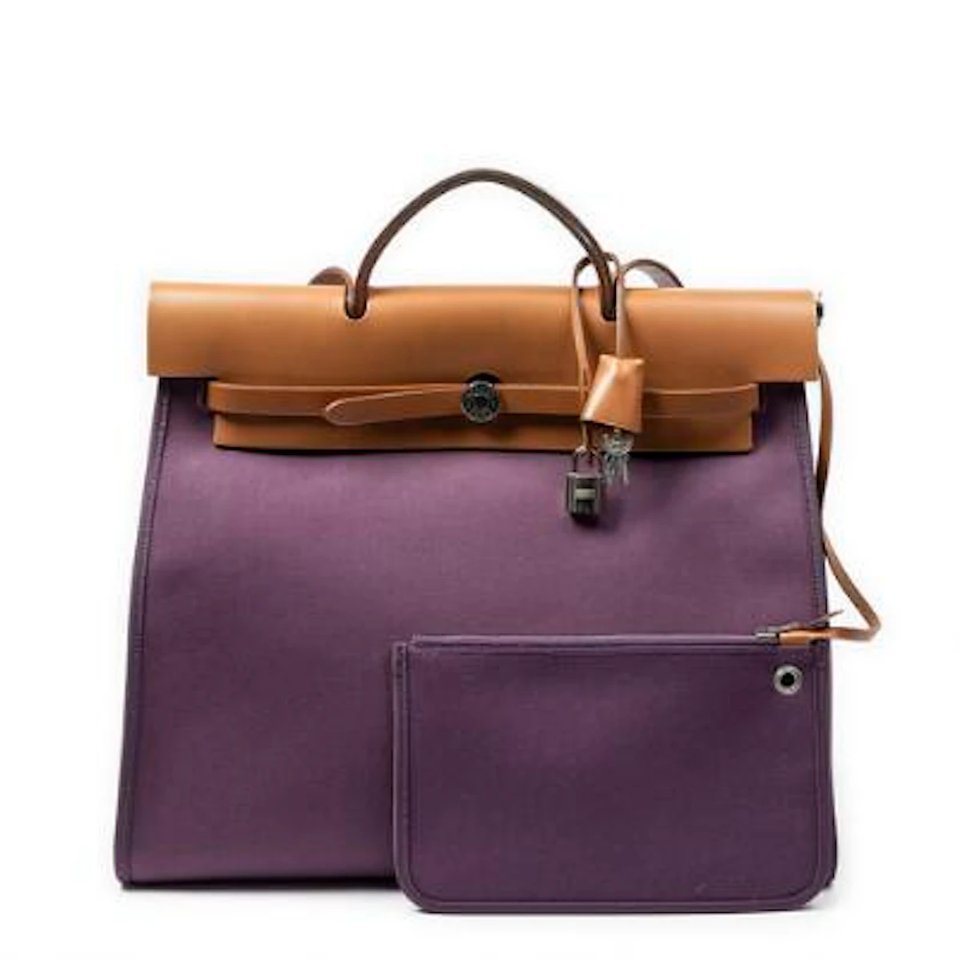 Hermès: A "Herbag" of brown leather and purple canvas with palladium