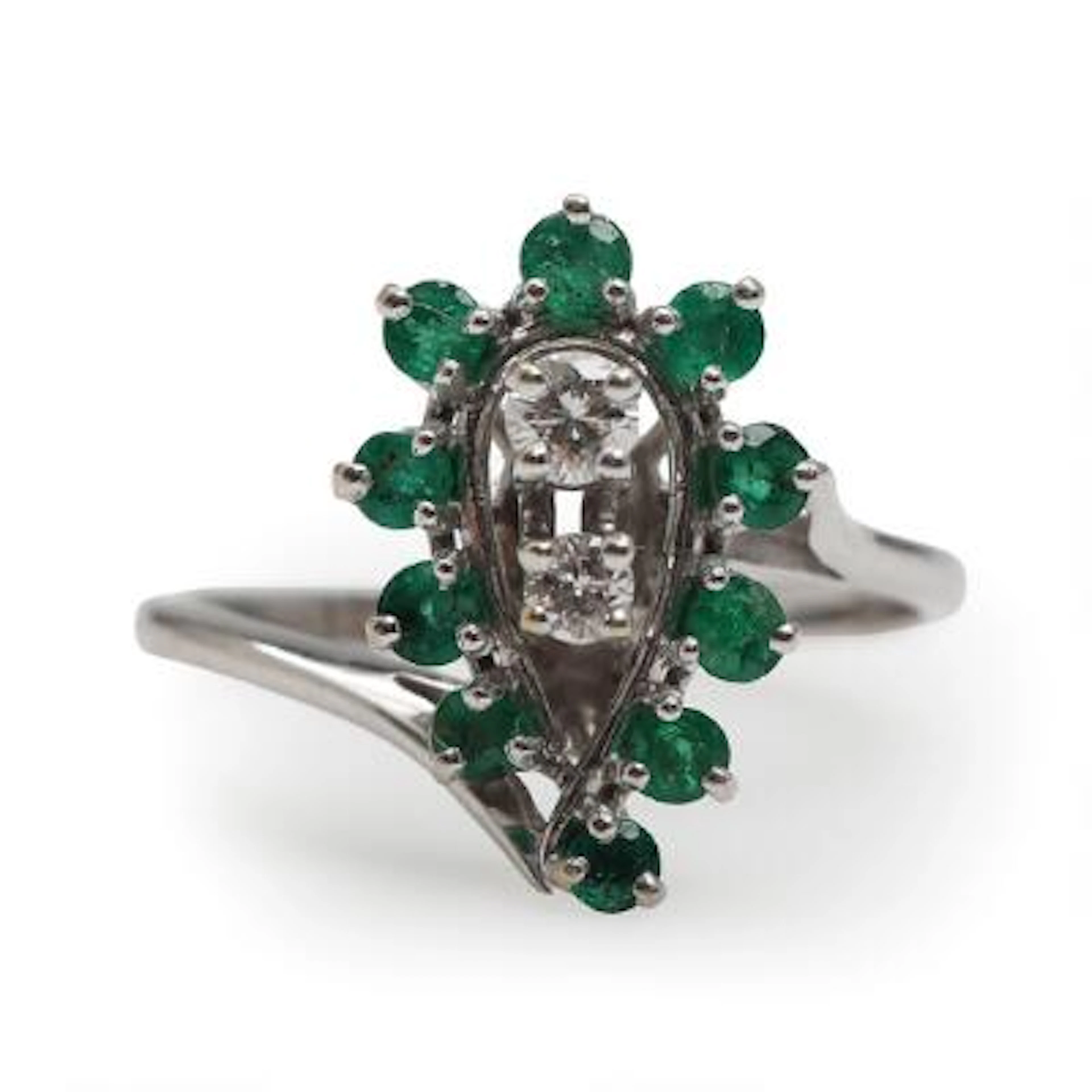 An emerald and diamond ring set with faceted emeralds and brilliant-cut