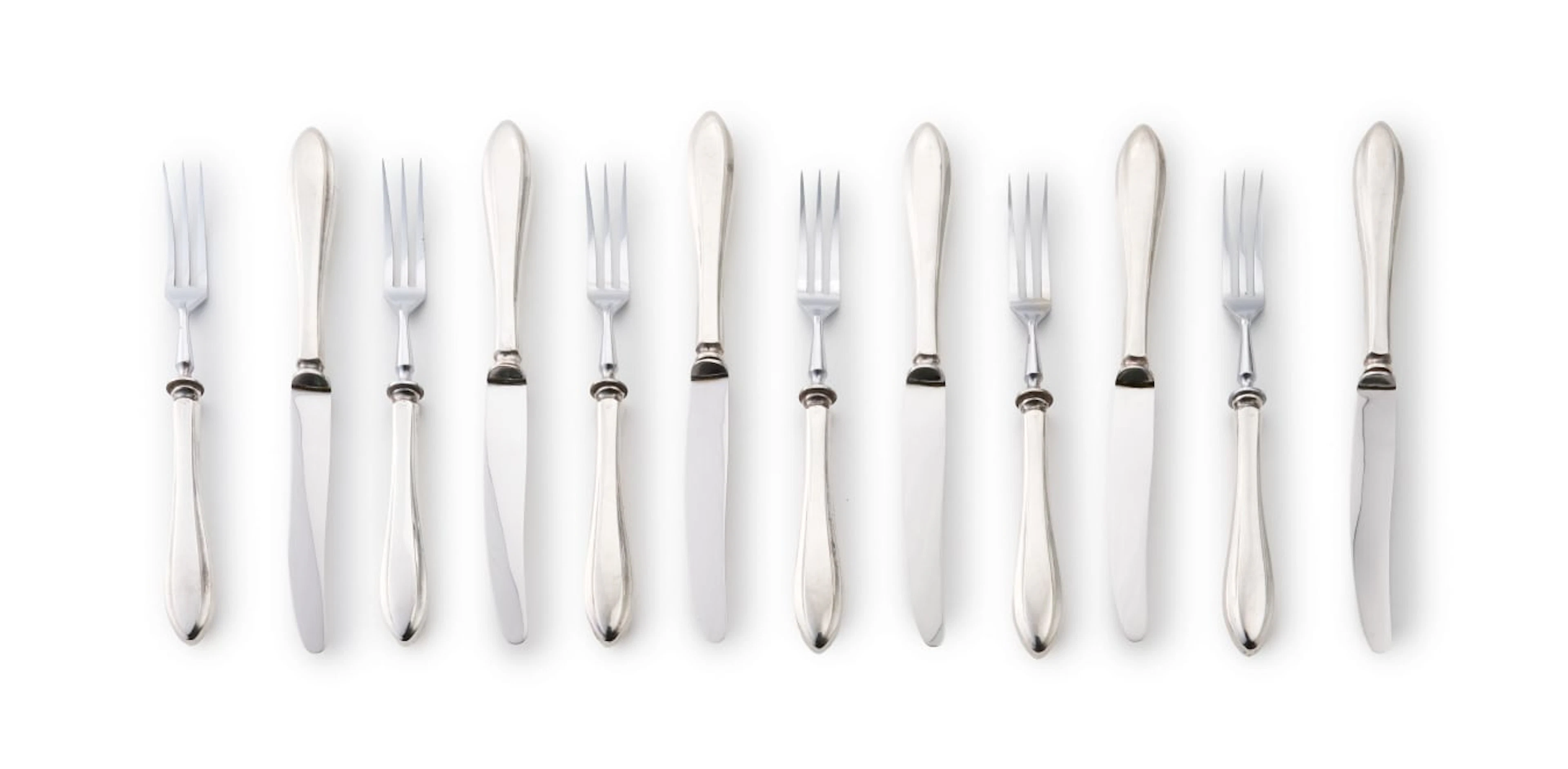 A set of six silver-handled fruit knives and forks with stainless