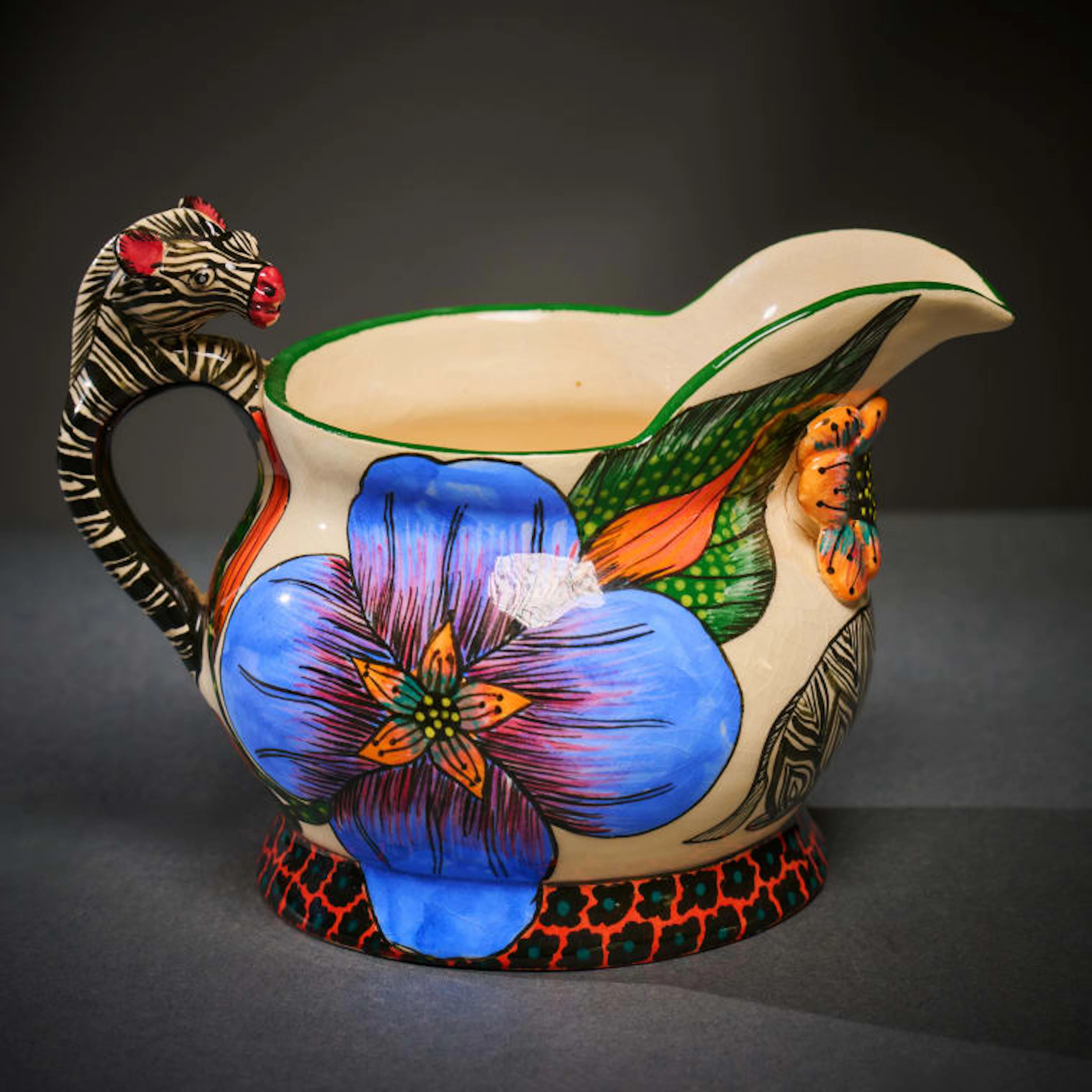 Ardmore Ceramic Studio; Zebra milk jug with blue flowers