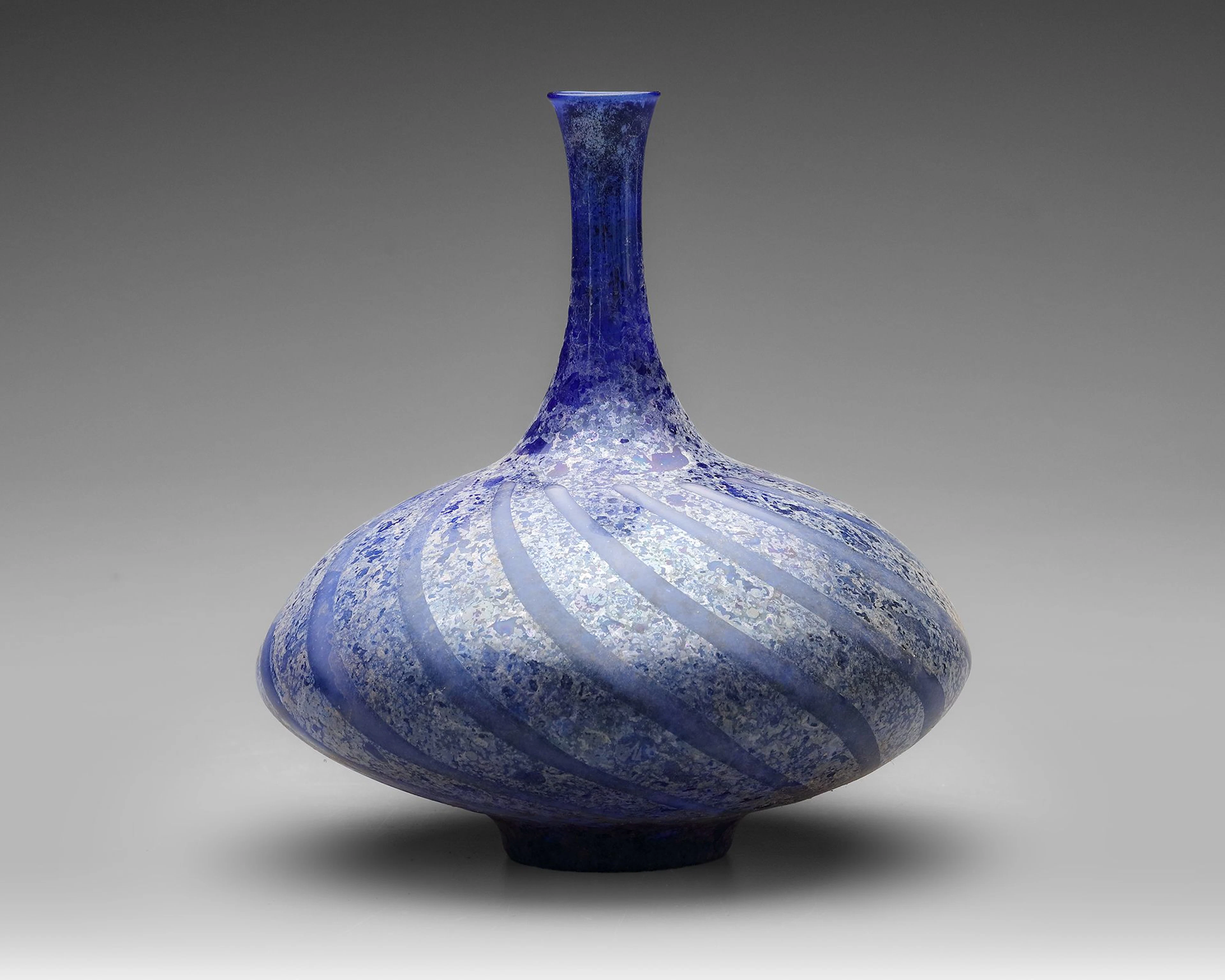 A BLUE GLASS BOTTLE, PERSIA OR SYRIA, 11TH–12TH CENTURY