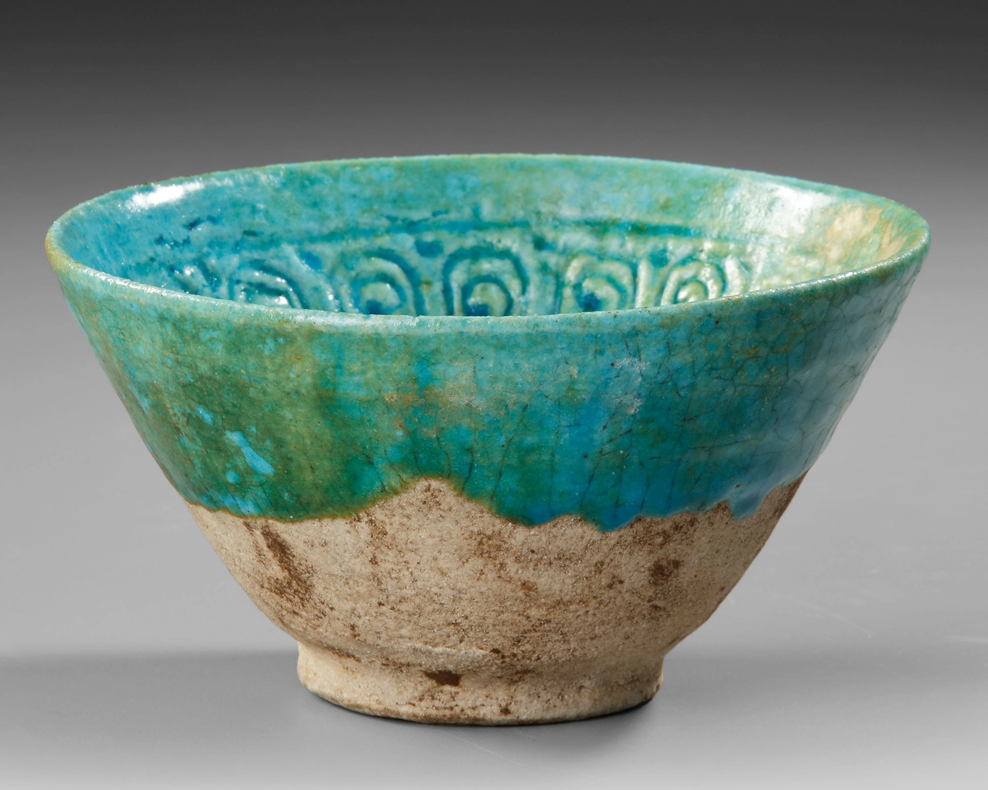 A BAMIYAN MONOCHROME MOULDED POTTERY BOWL, PERSIA, 12TH-13TH CENTURY