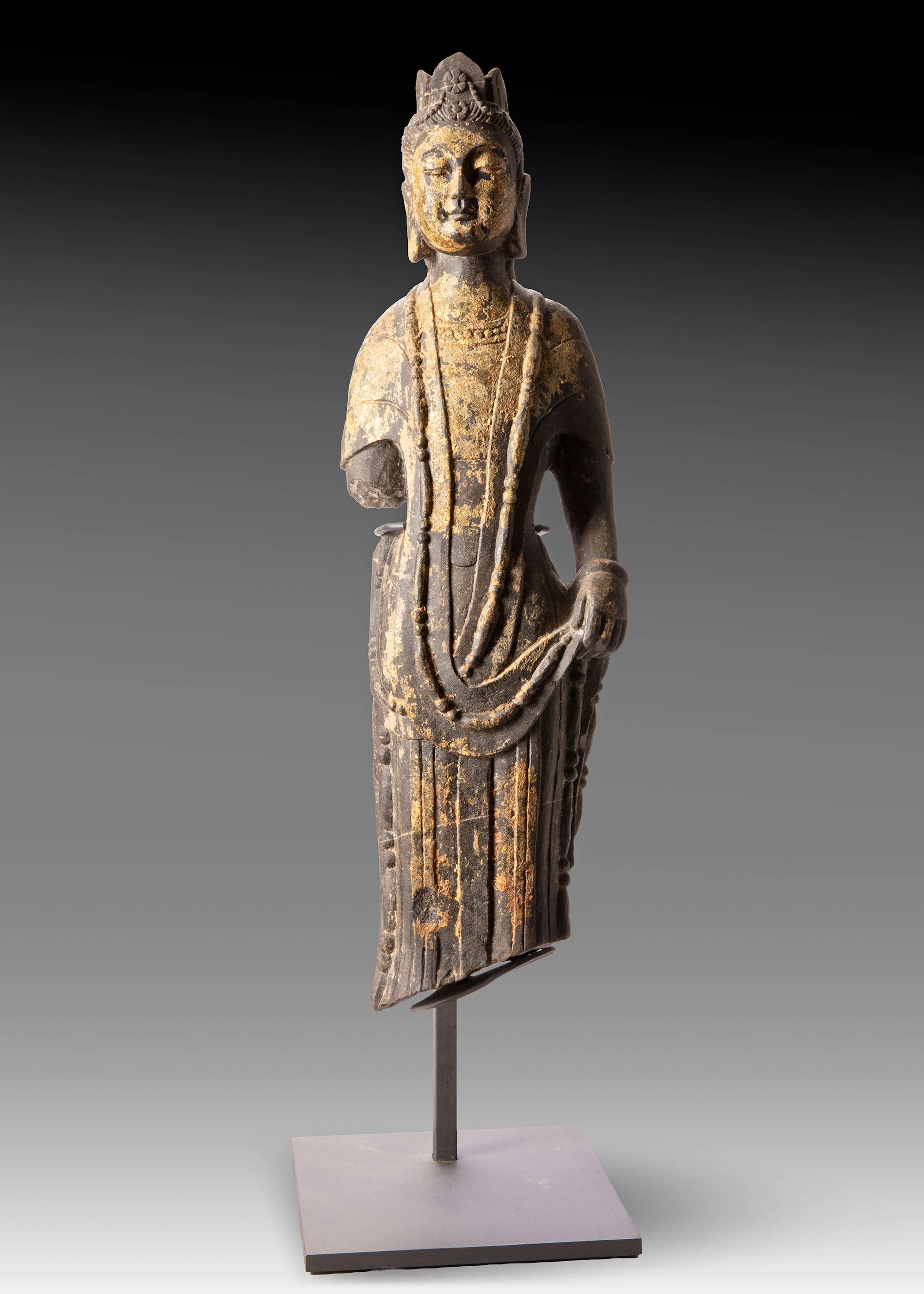 A FINELY CARVED STONE FIGURE OF A STANDING BUDDHIST DEITY
