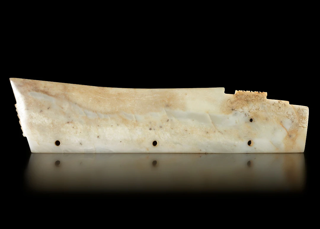 AN IVORY WHITE JADE BLADE, “GE", CHINA, LONGSHAN CULTURE