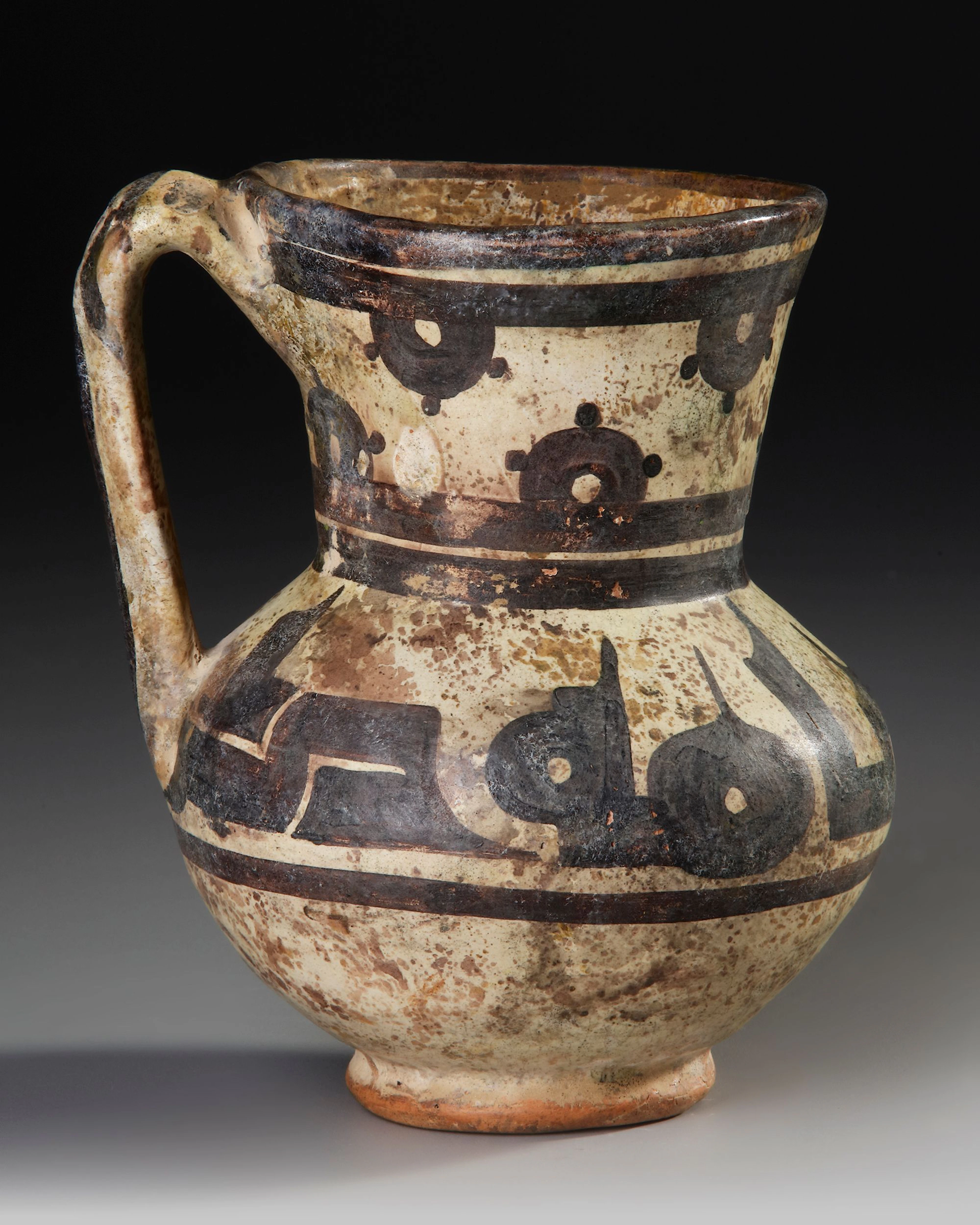 A SAMANID SLIP-PAINTED CALLIGRAPHIC POTTERY JUG, NISHAPUR OR SAMARKAND