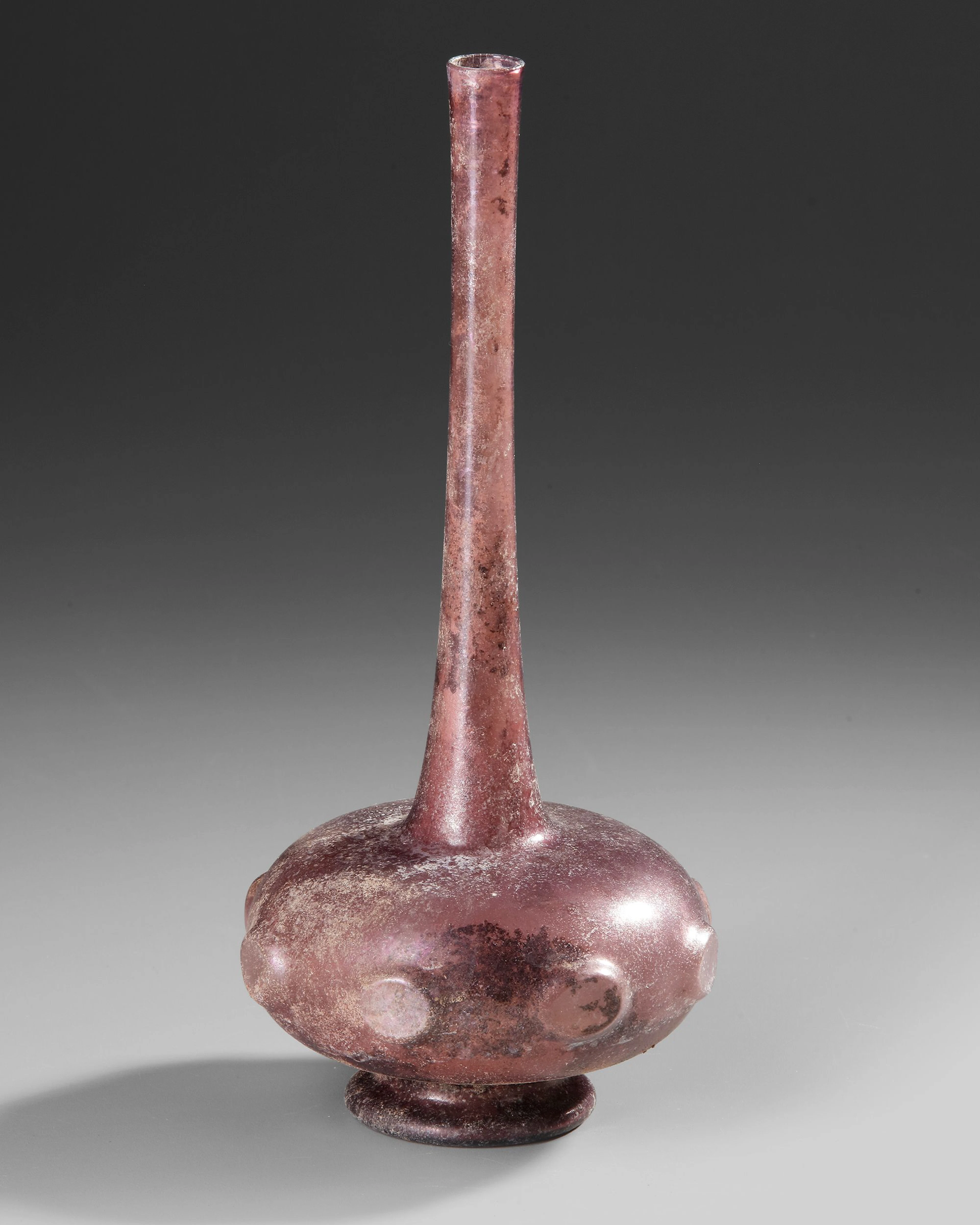 A PURPLE GLASS SPRINKLER FLASK, PERSIA OR SYRIA, 9TH–11TH CENTURY