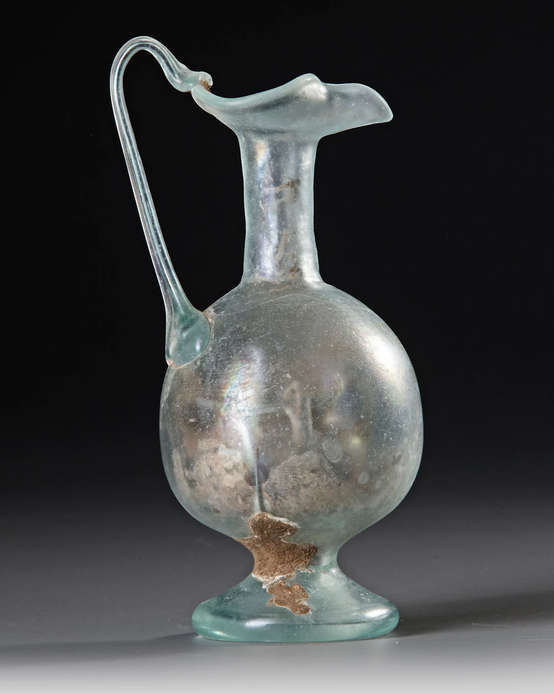 A ROMAN PALE GREEN GLASS EWER, CIRCA 1ST–3RD CENTURY A.D.