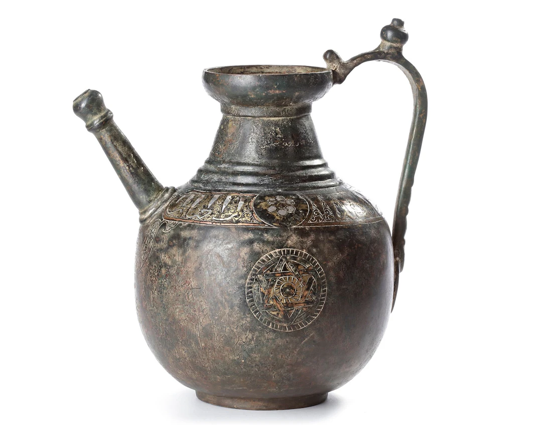 A KHURASAN SILVER-INLAID BRONZE EWER, PERSIA, 12TH CENTURY