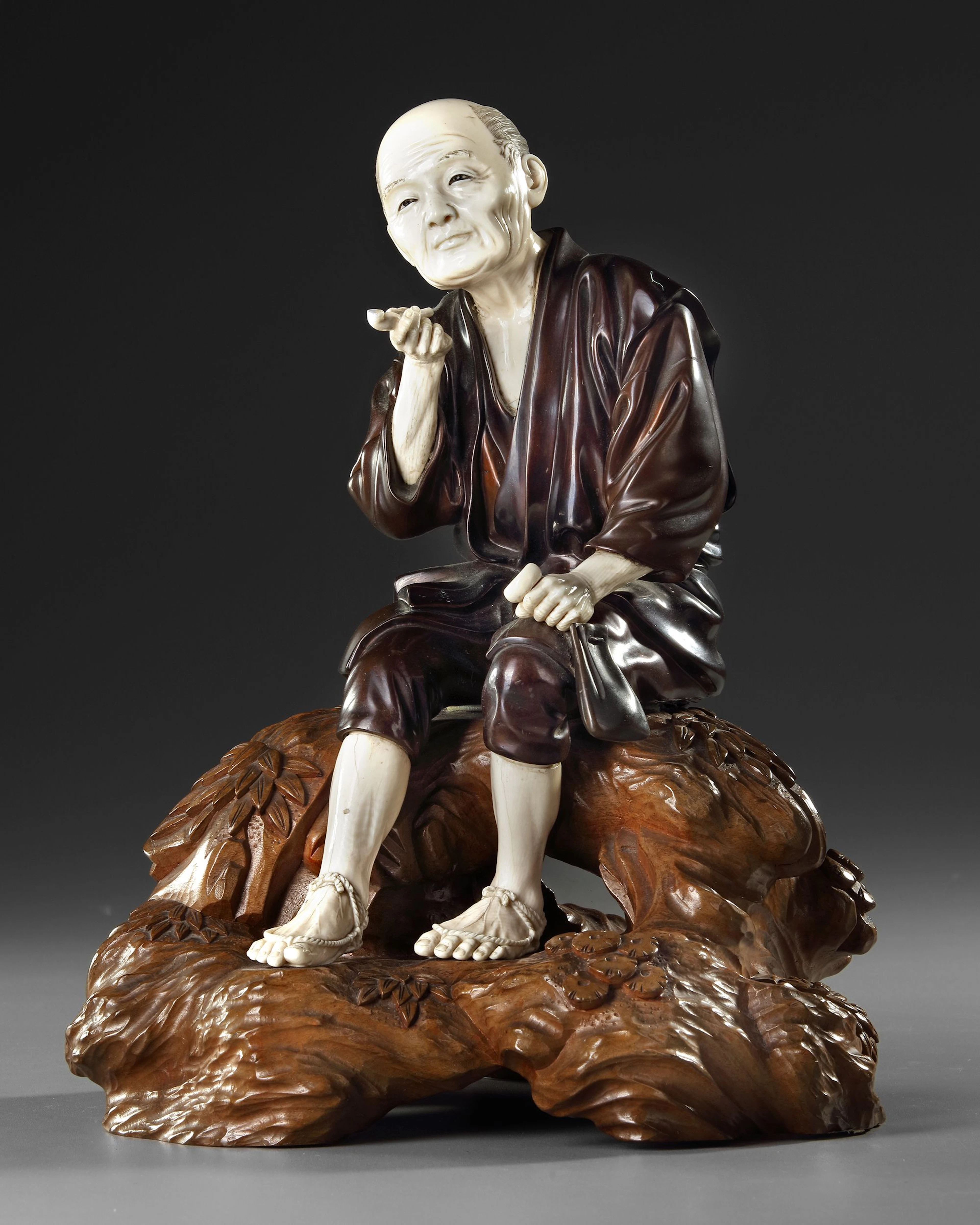 A LARGE JAPANESE BRONZE AND BONE OKIMONO OF A PIPE SMOKER, MEIJI PERIOD