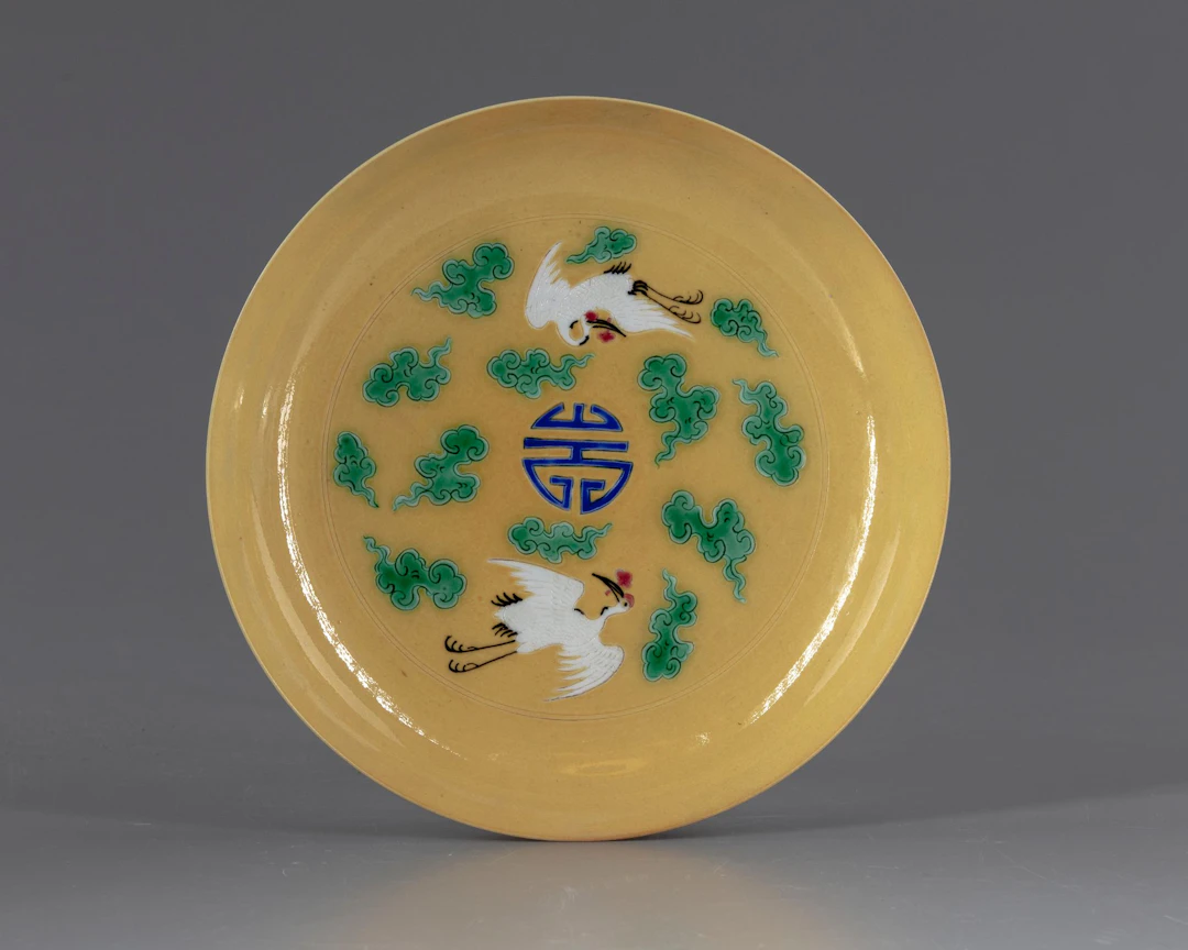 A CHINESE CRANES YELLOW DISH, 20TH CENTURY