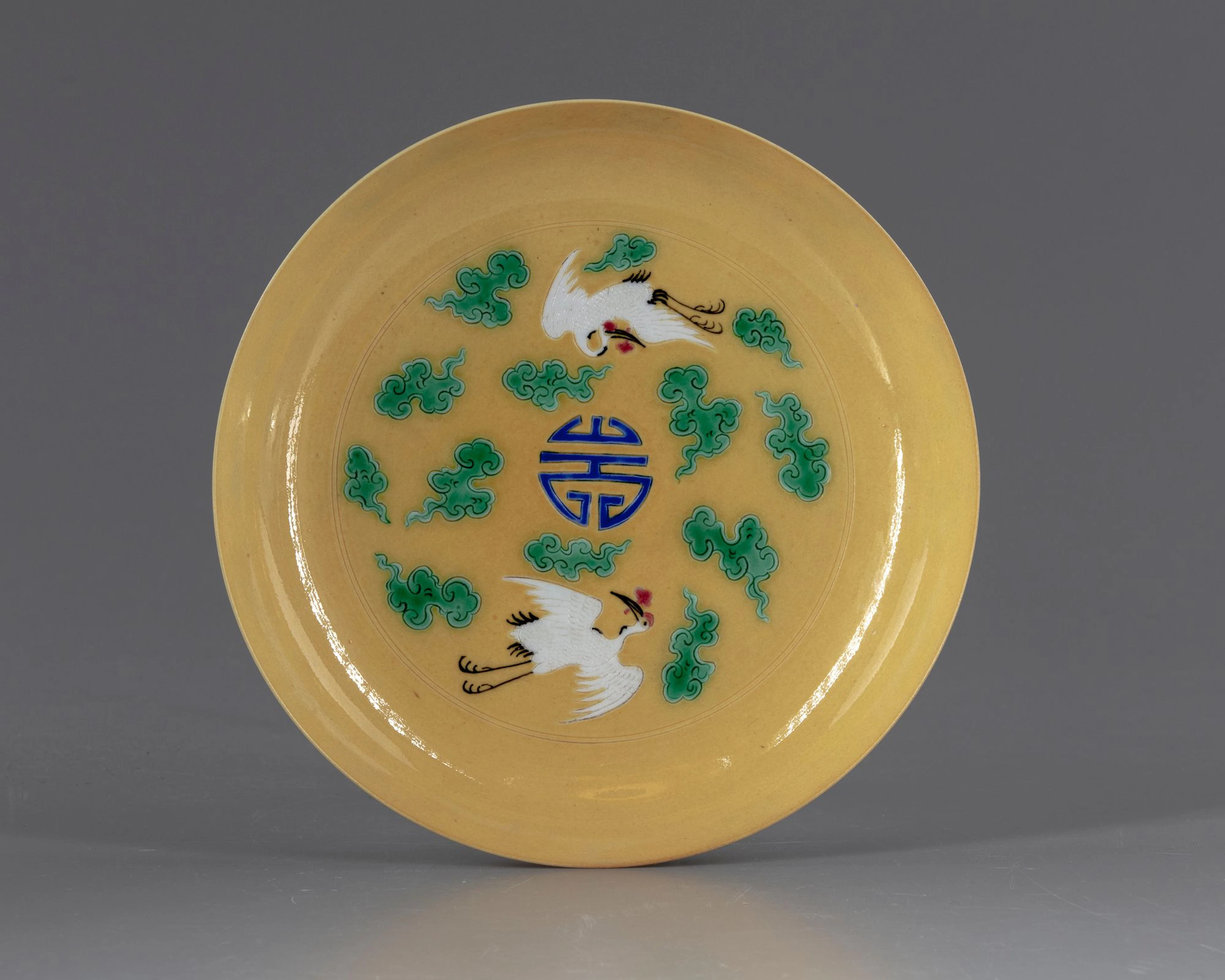 A CHINESE CRANES YELLOW DISH, 20TH CENTURY